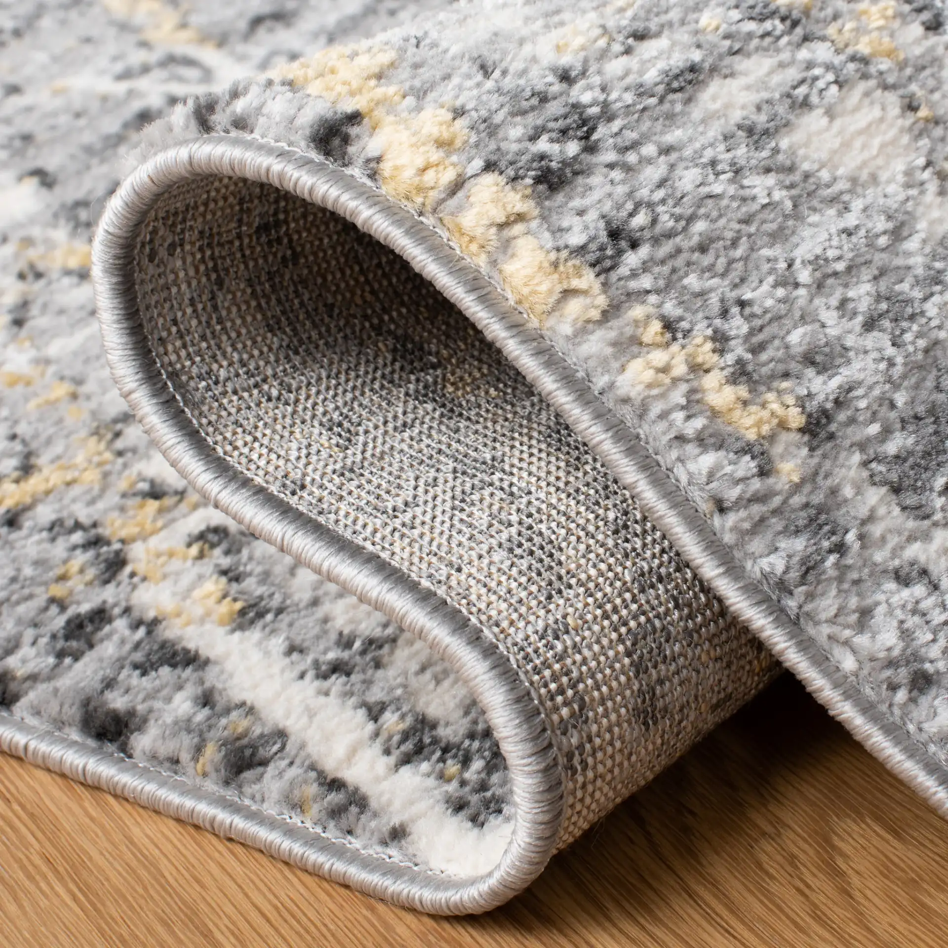 Lagoon Diamond Lattice Rug in Gray / Gold in a styled room