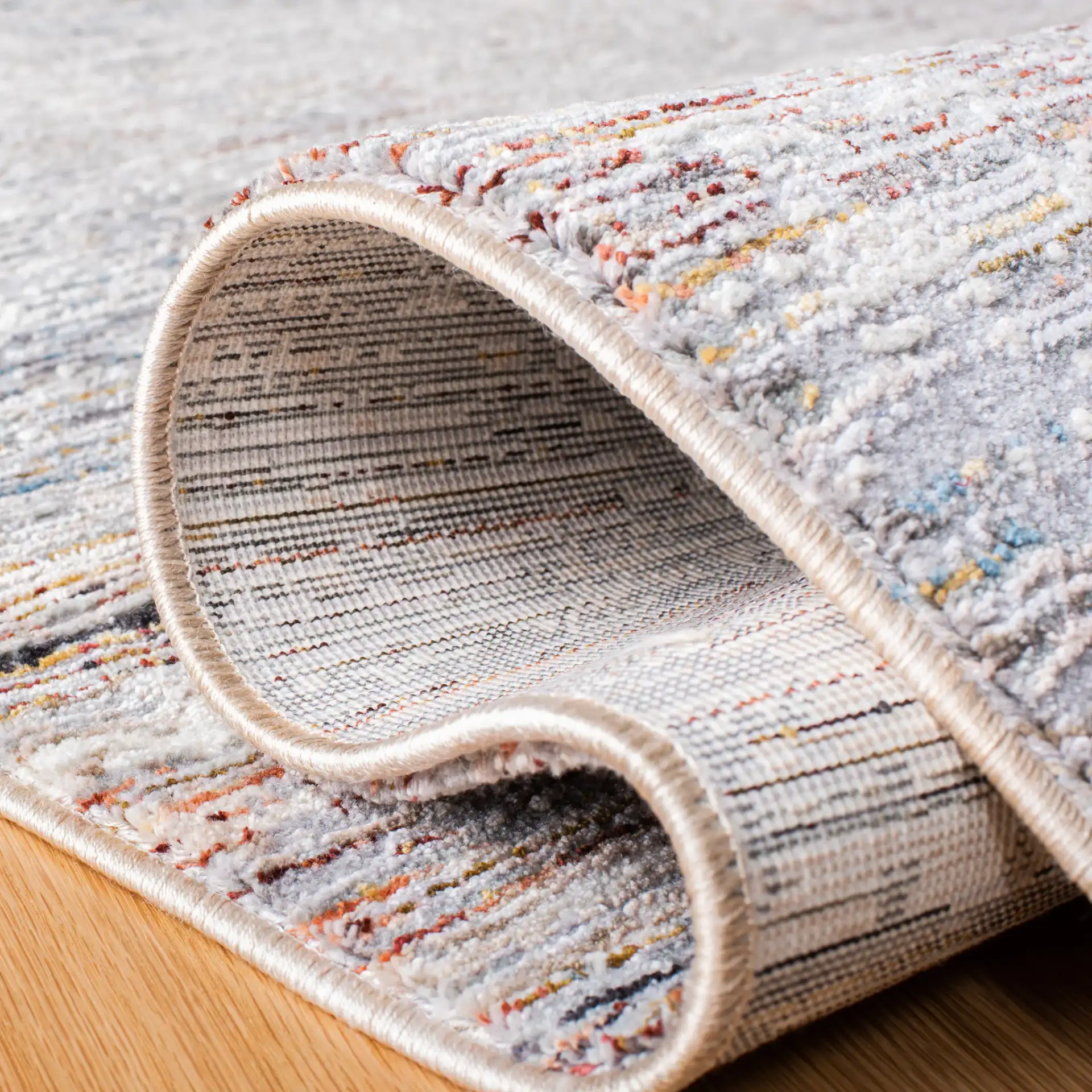 Limitee Distressed Abstract Rug in Gray / Beige in a styled room