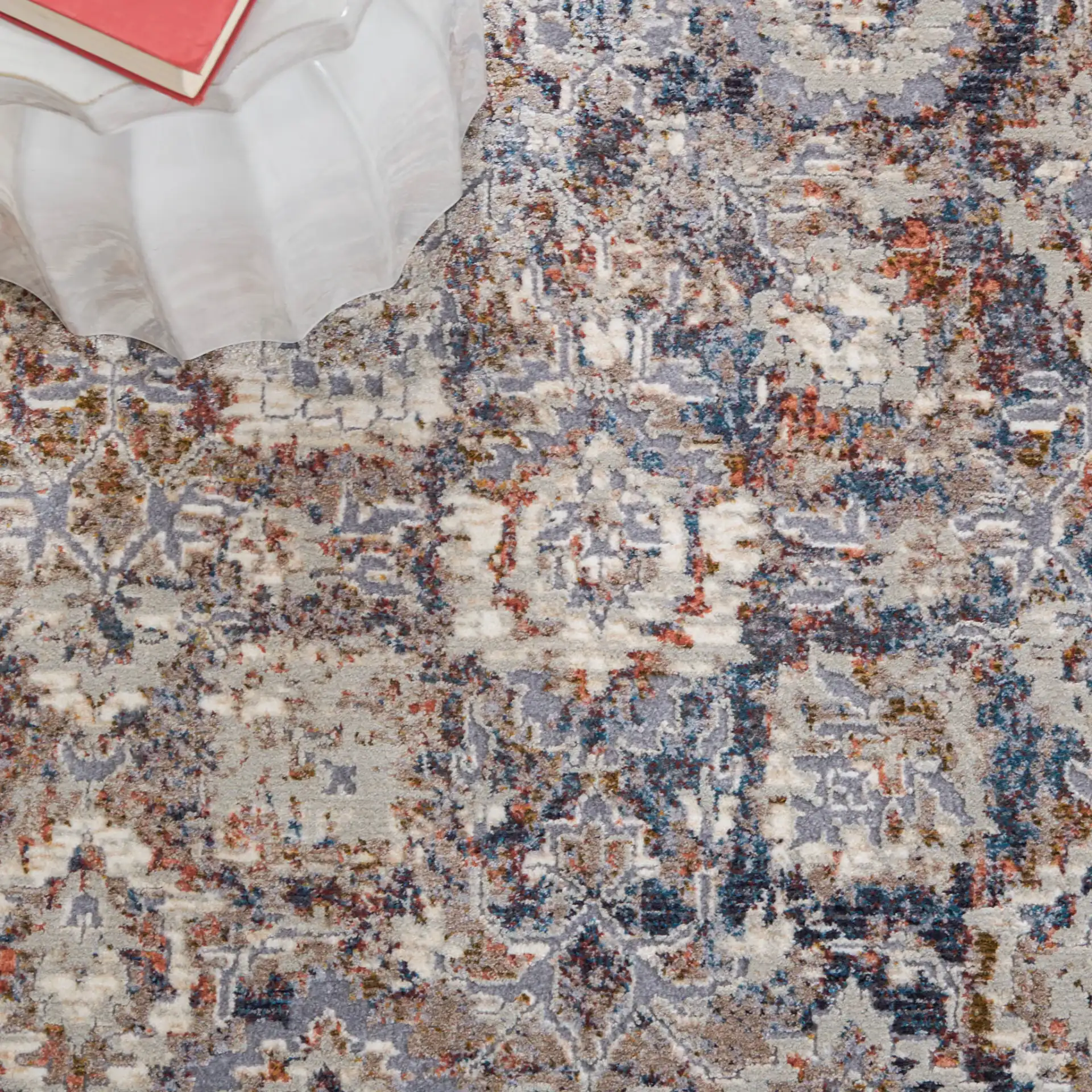 Limitee Distressed Floral Border Rug in Charcoal / Beige in a styled room