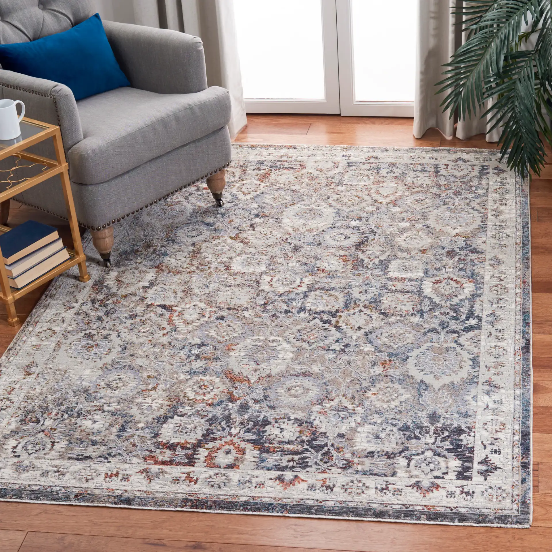 Limitee Distressed Floral Border Rug in Charcoal / Beige in a styled room