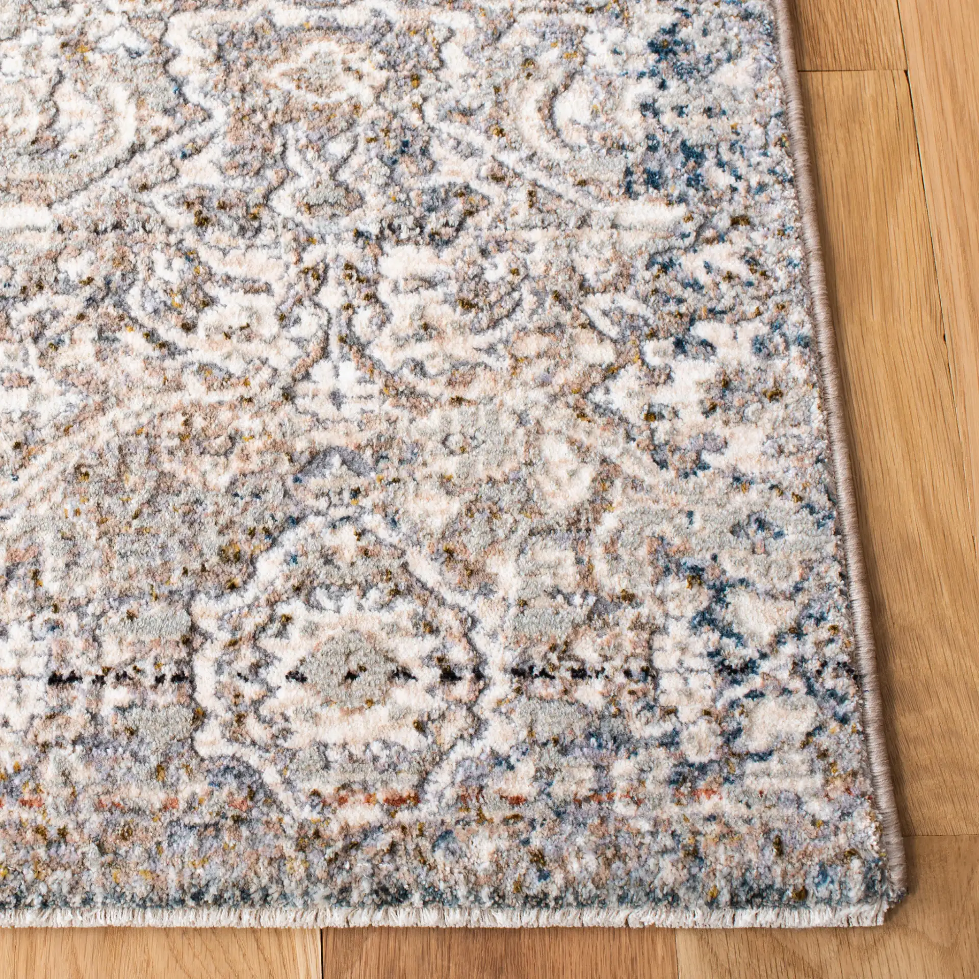 Limitee Distressed Damask Rug in Beige in a styled room