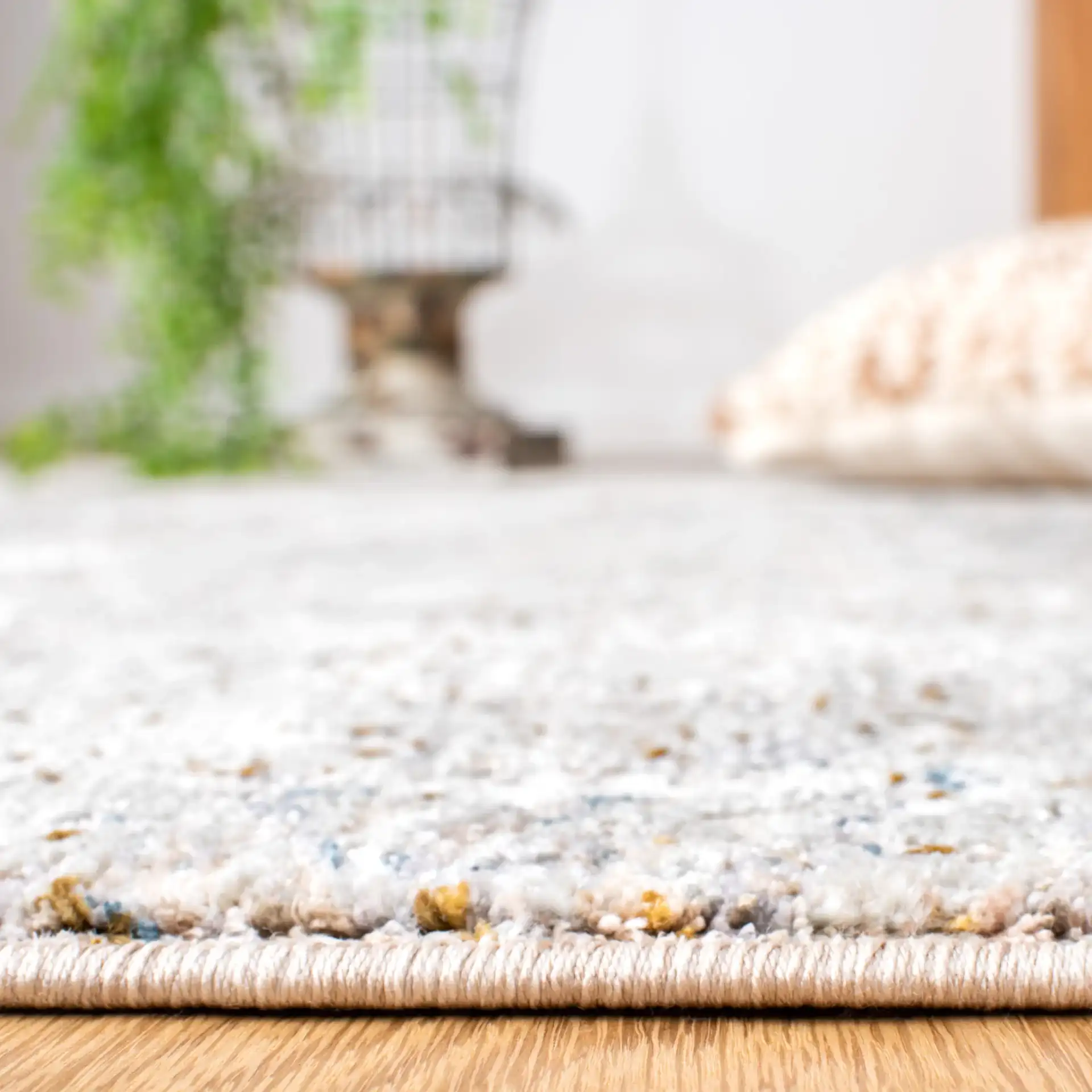 Limitee Distressed Damask Rug in Beige in a styled room