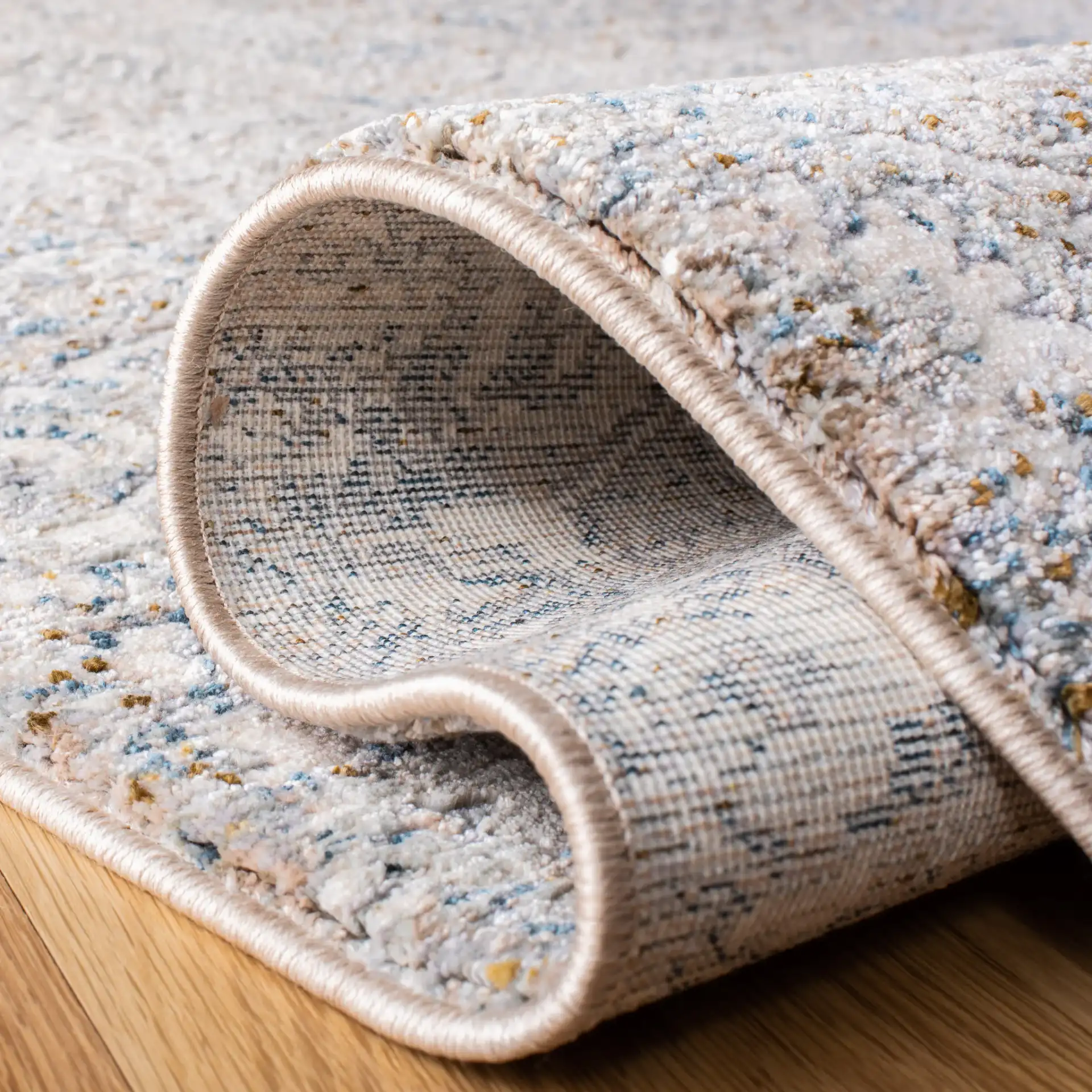 Limitee Distressed Damask Rug in Beige in a styled room