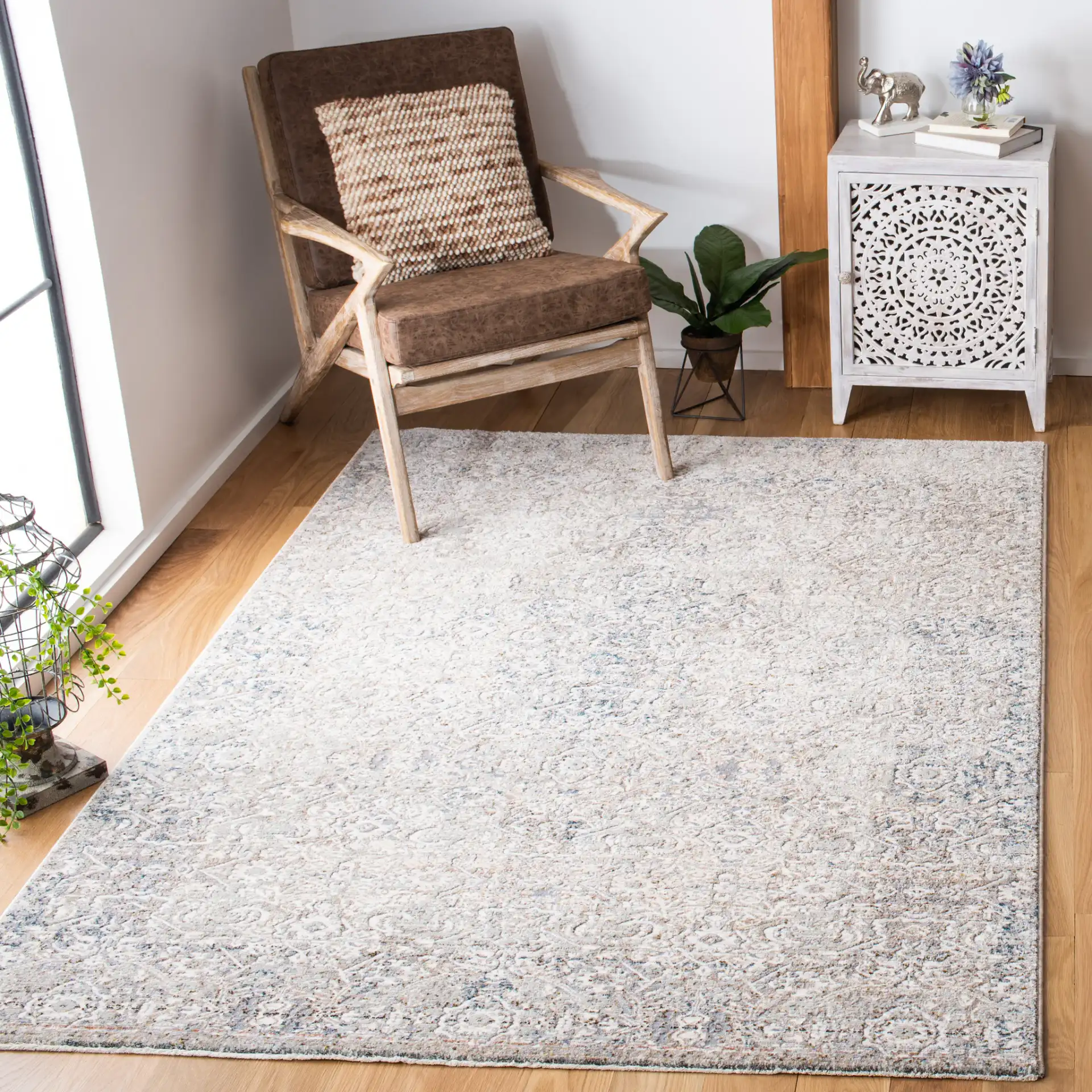 Limitee Distressed Damask Rug in Beige in a styled room