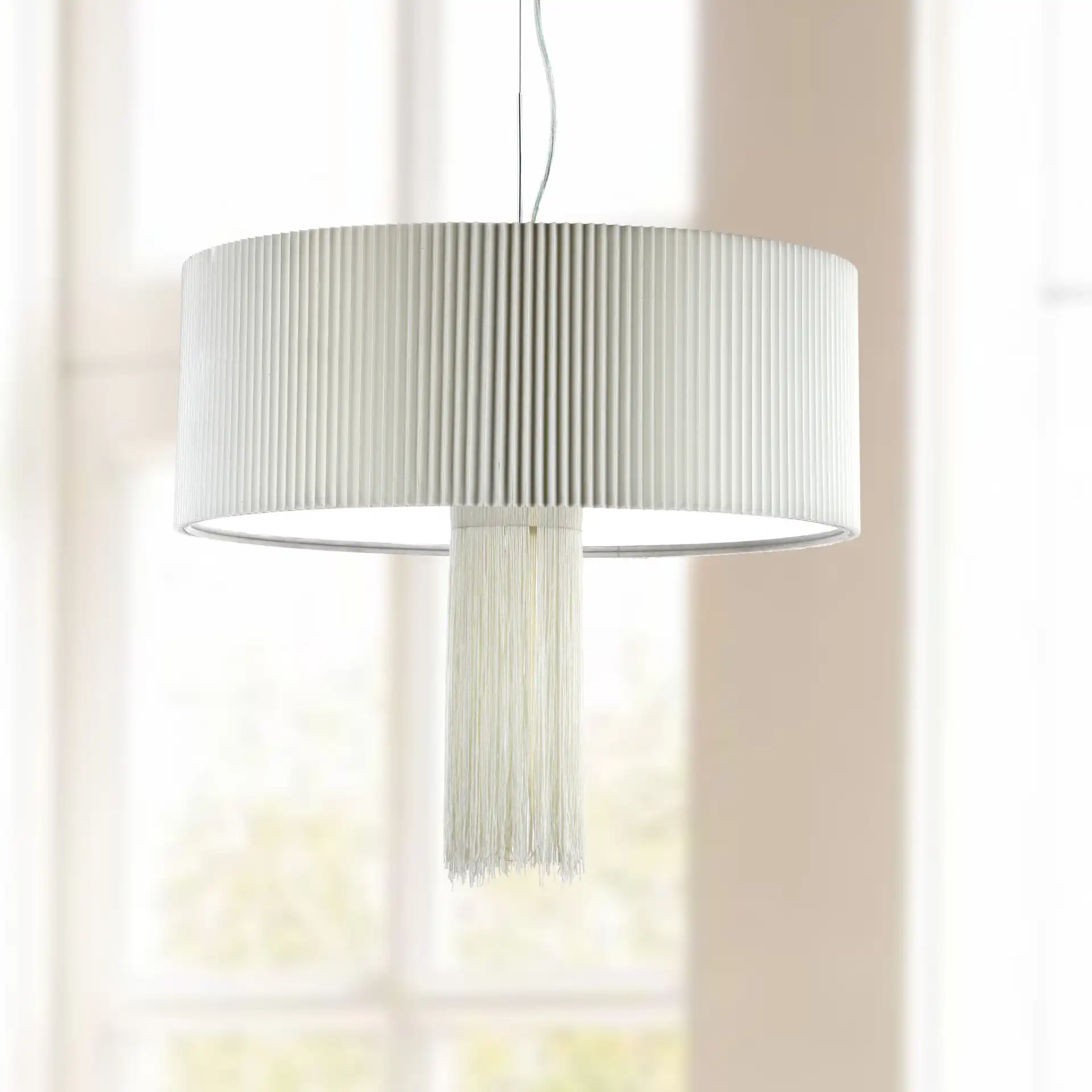 Schroom Pendant in Chrome in a styled room