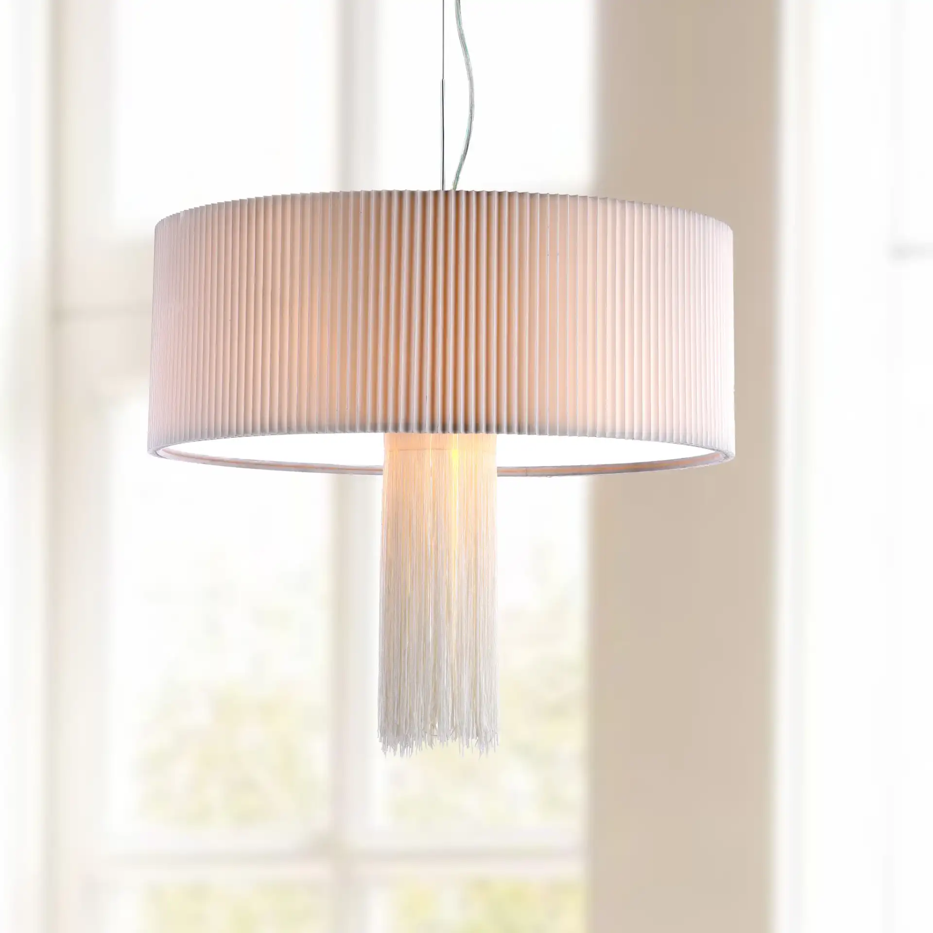 Schroom Pendant in Chrome in a styled room