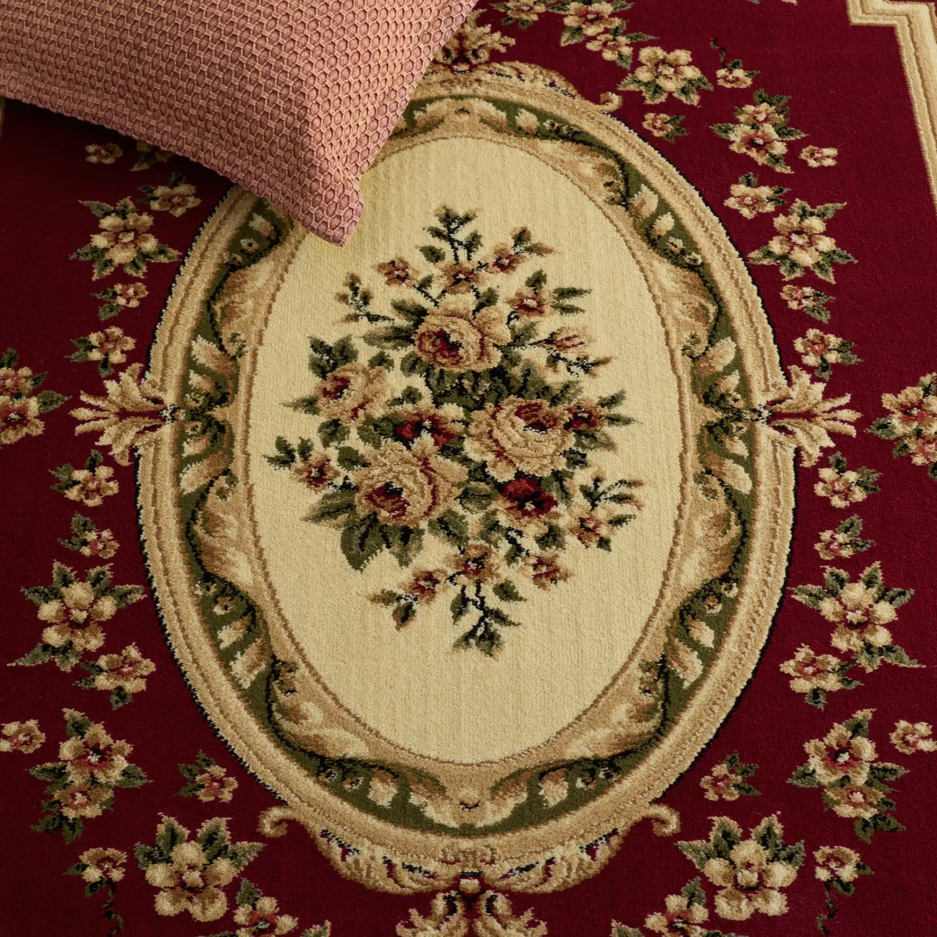 Lyndhurst Oval Floral Medallion Rug in Red / Ivory in a styled room