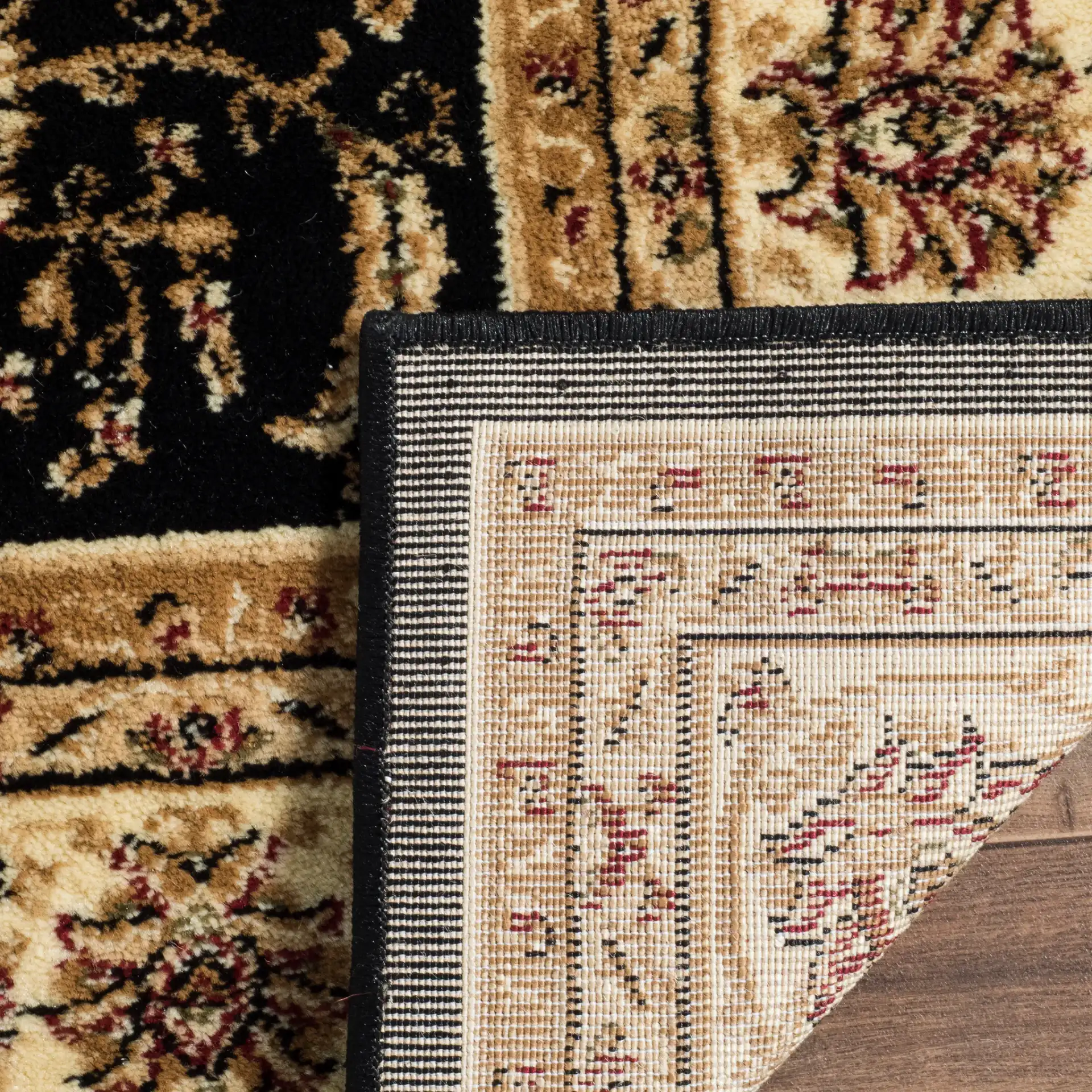 Lyndhurst Arabesque Bordered Rug in Black / Ivory in a styled room