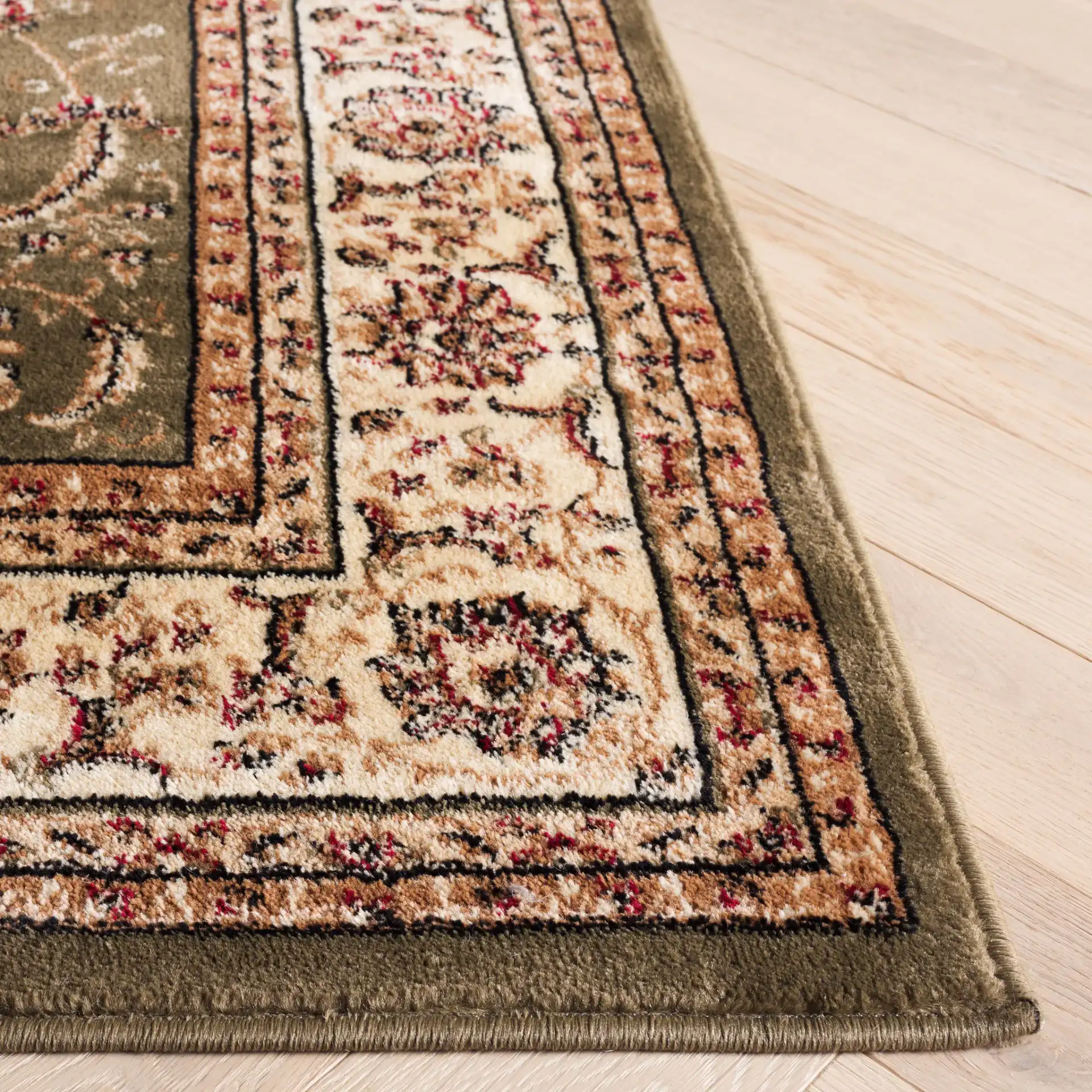 Lyndhurst Arabesque Bordered Rug in Sage / Ivory in a styled room
