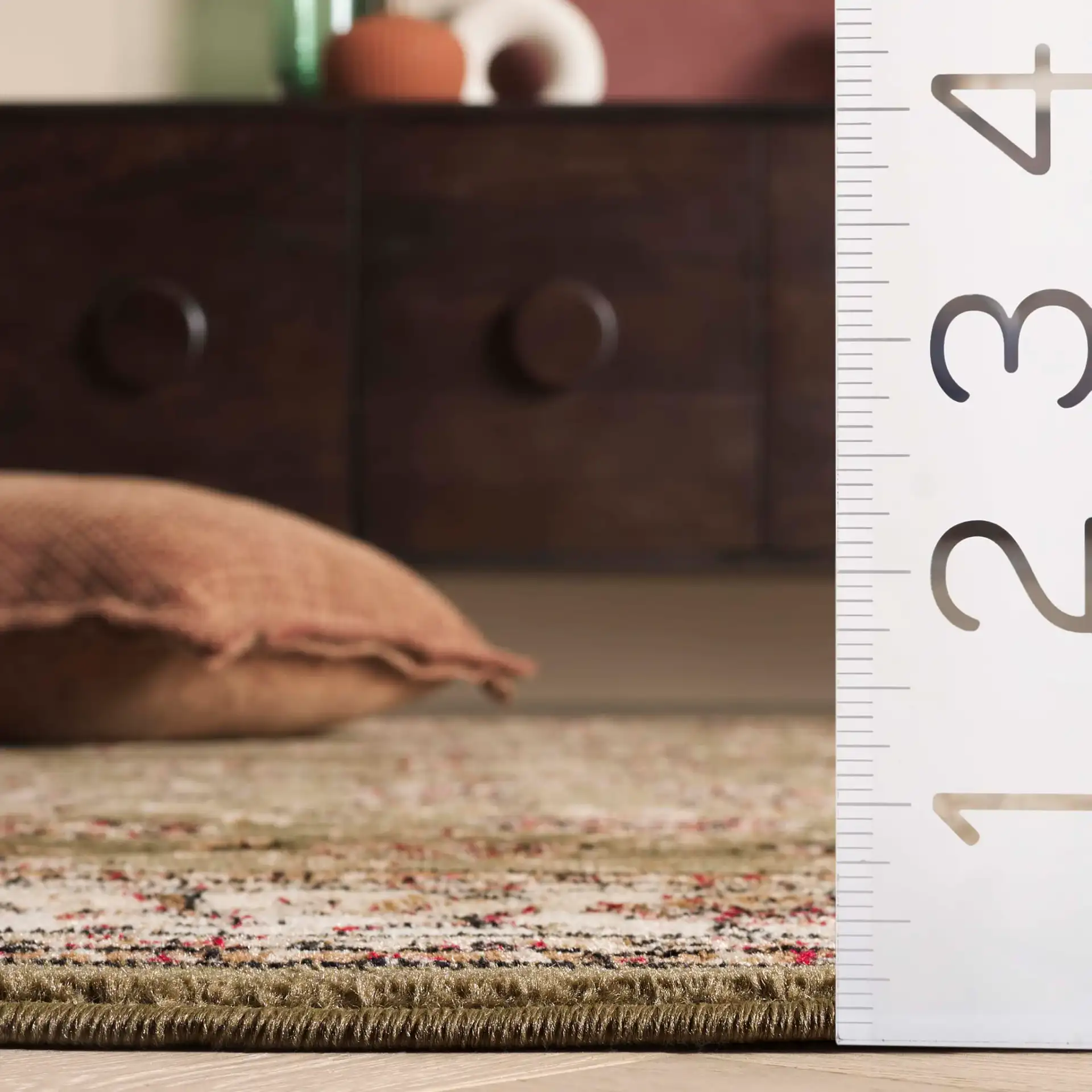 Lyndhurst Arabesque Bordered Rug in Sage / Ivory in a styled room