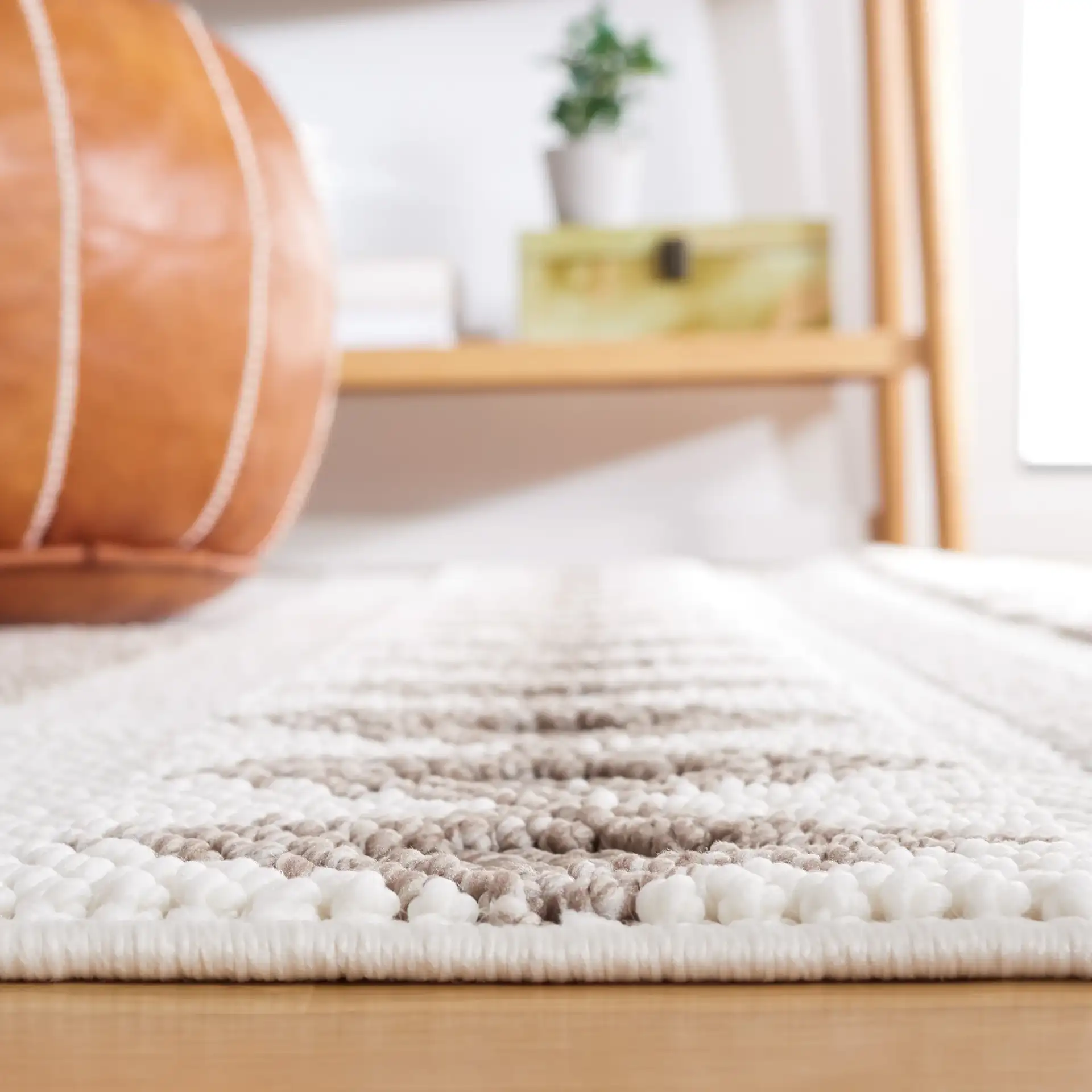 Lotus Banded Diamond Rug in Ivory / Beige in a styled room
