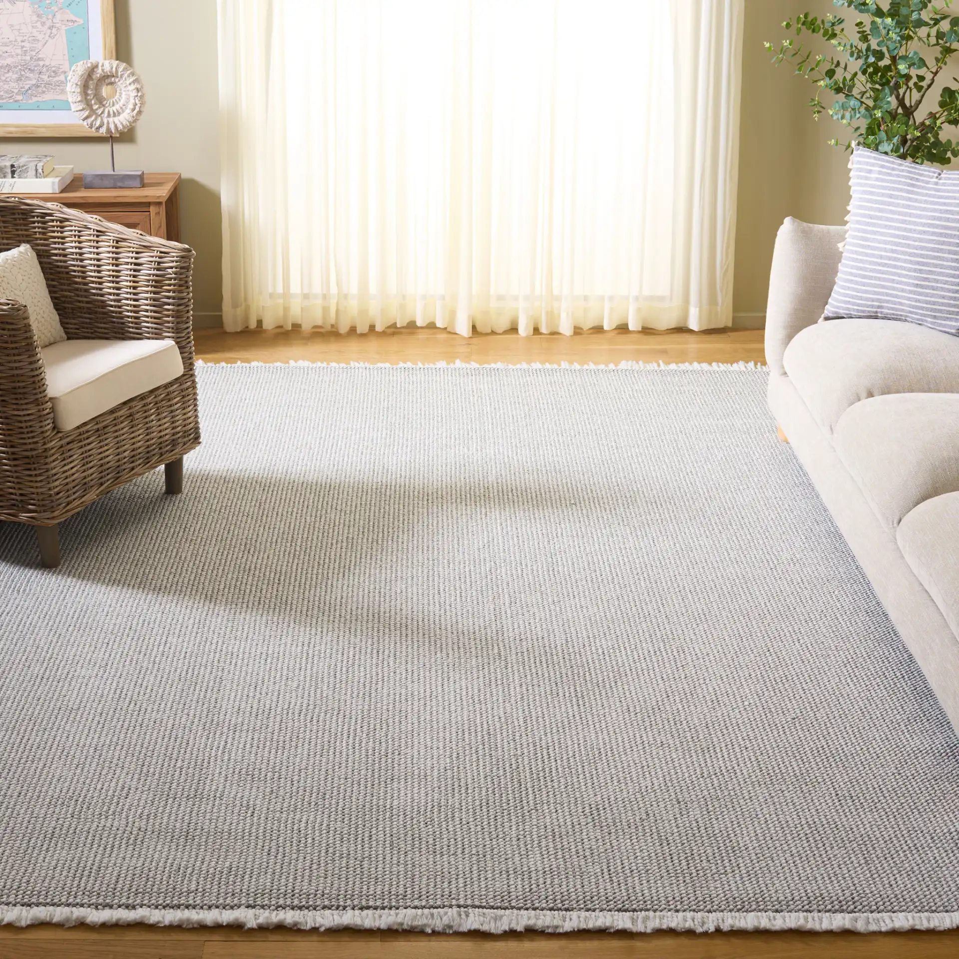 Lotus Solid Textured Rug in Light Gray / Ivory in a styled room