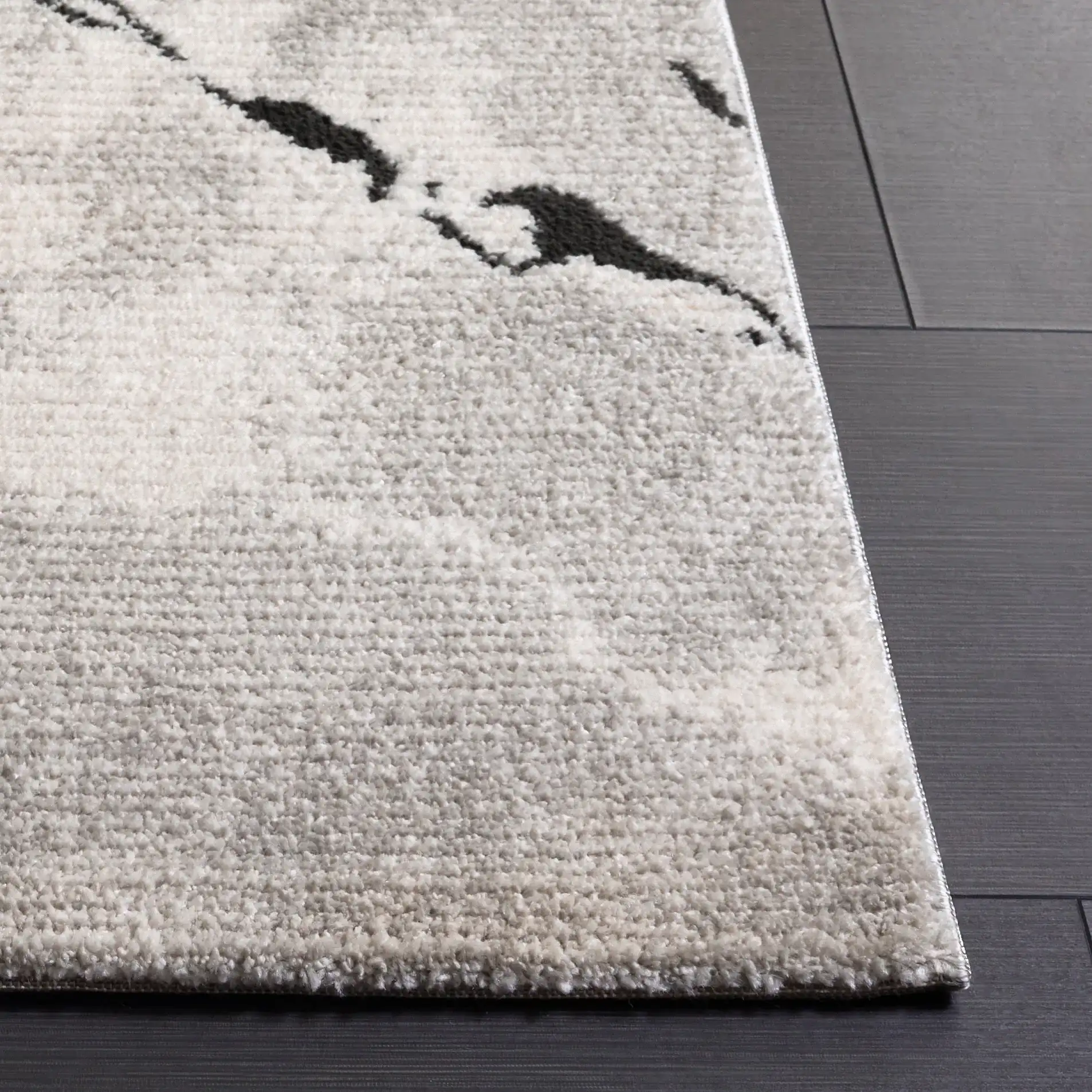Lunara Modern Marble Rug in Ivory / Charcoal in a styled room