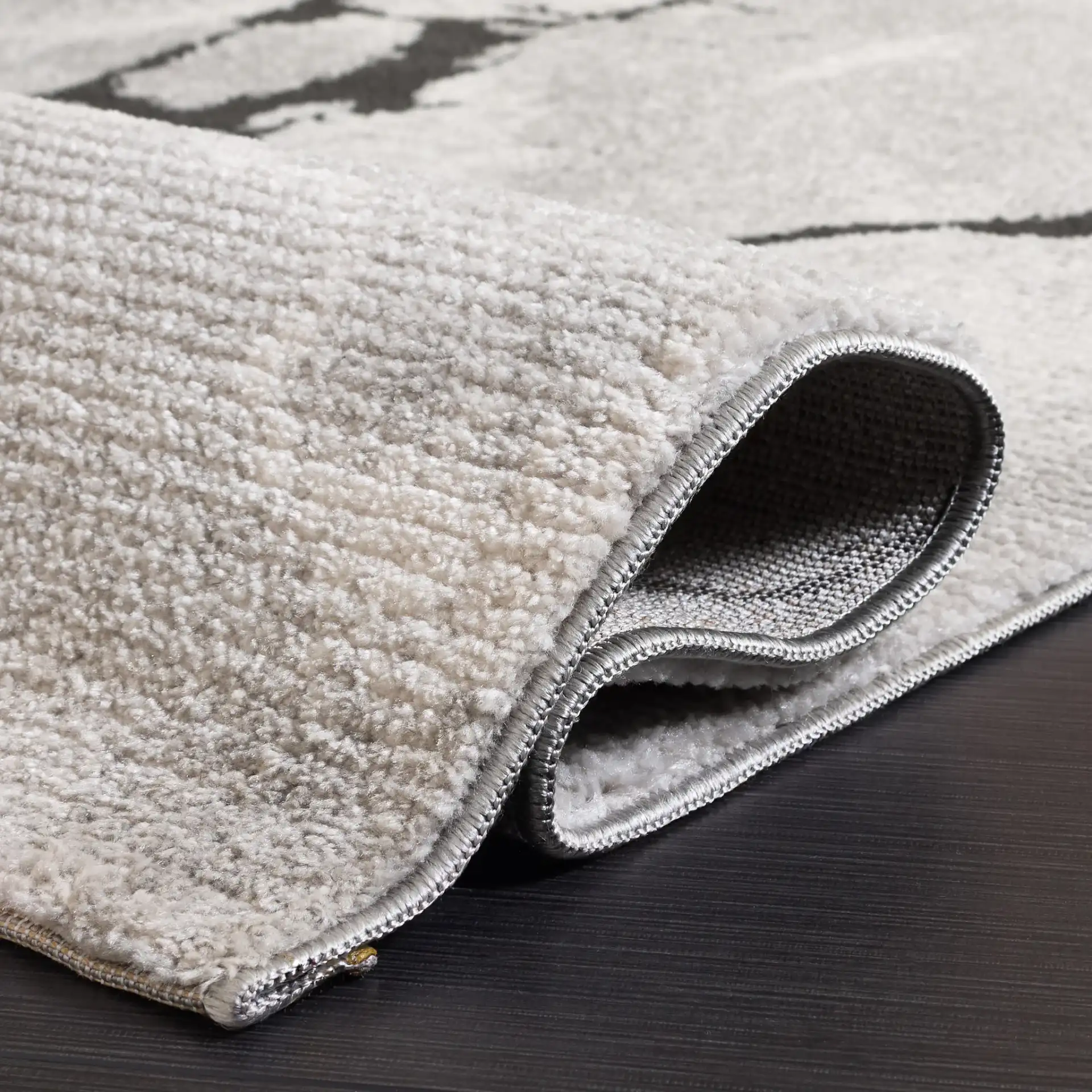 Lunara Modern Marble Rug in Ivory / Charcoal in a styled room