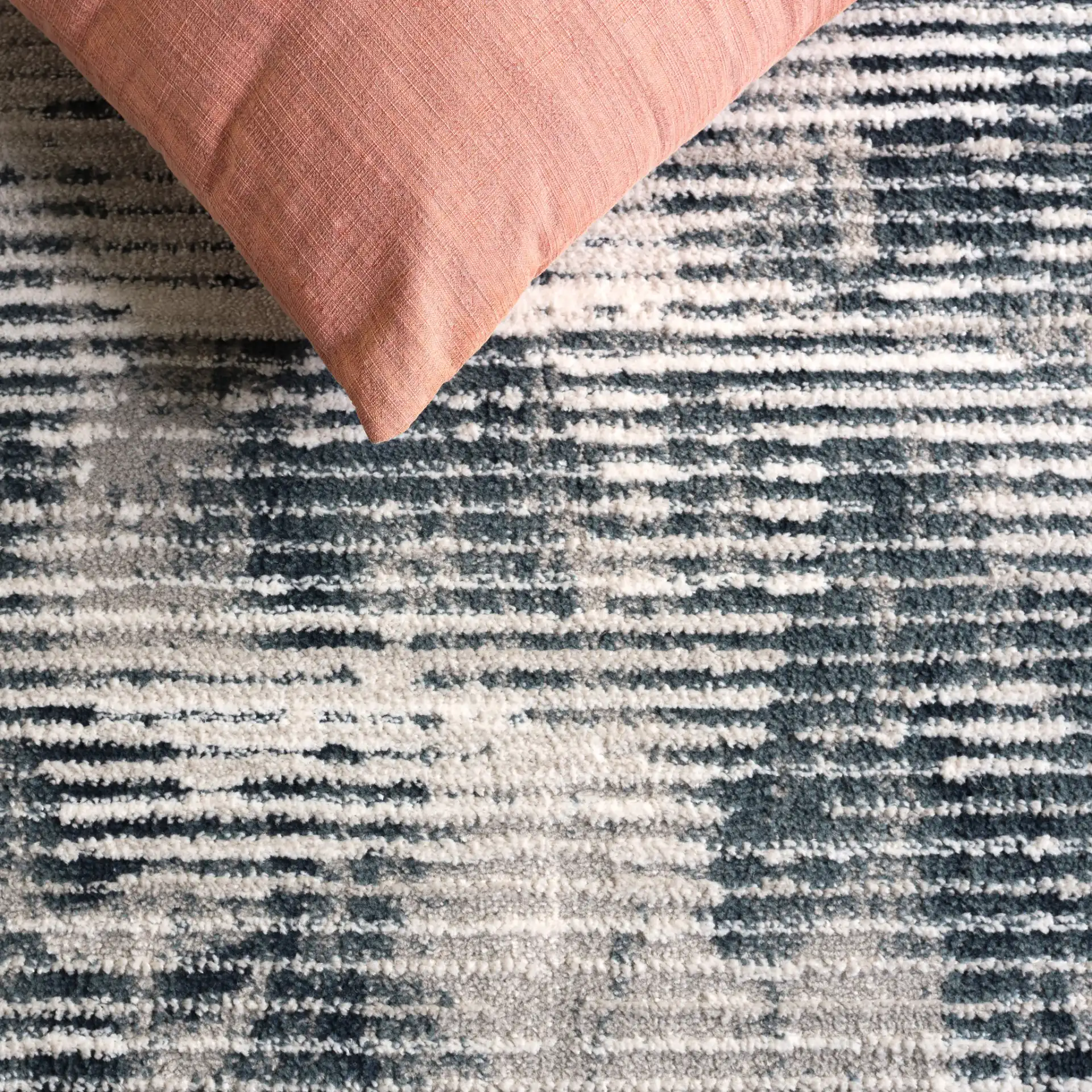 Lunara Modern Striated Rug in Ivory / Blue in a styled room