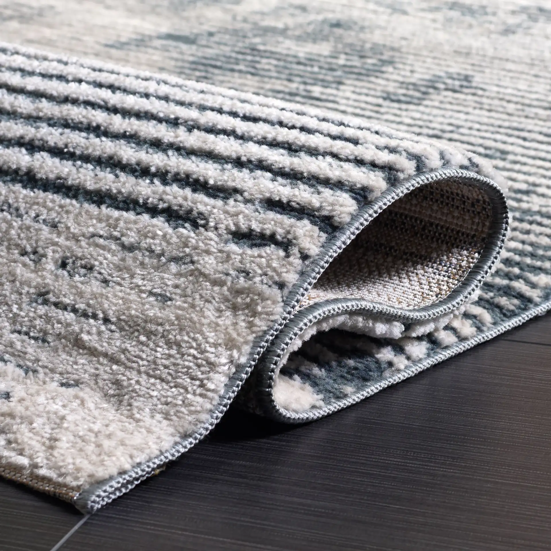 Lunara Modern Striated Rug in Ivory / Blue in a styled room