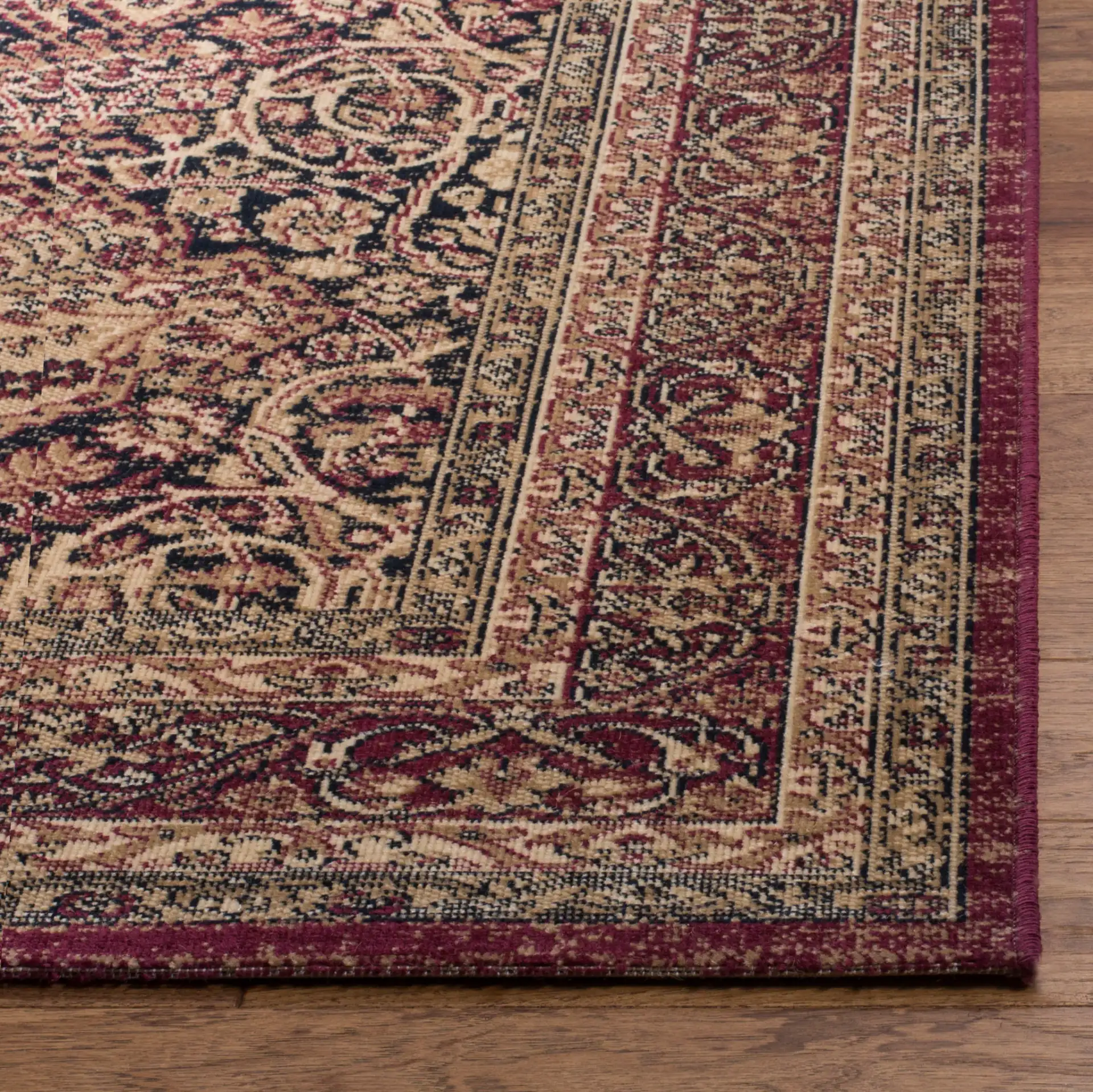 Lavar Kerman Arabesque Bordered Rug in Navy / Red in a styled room