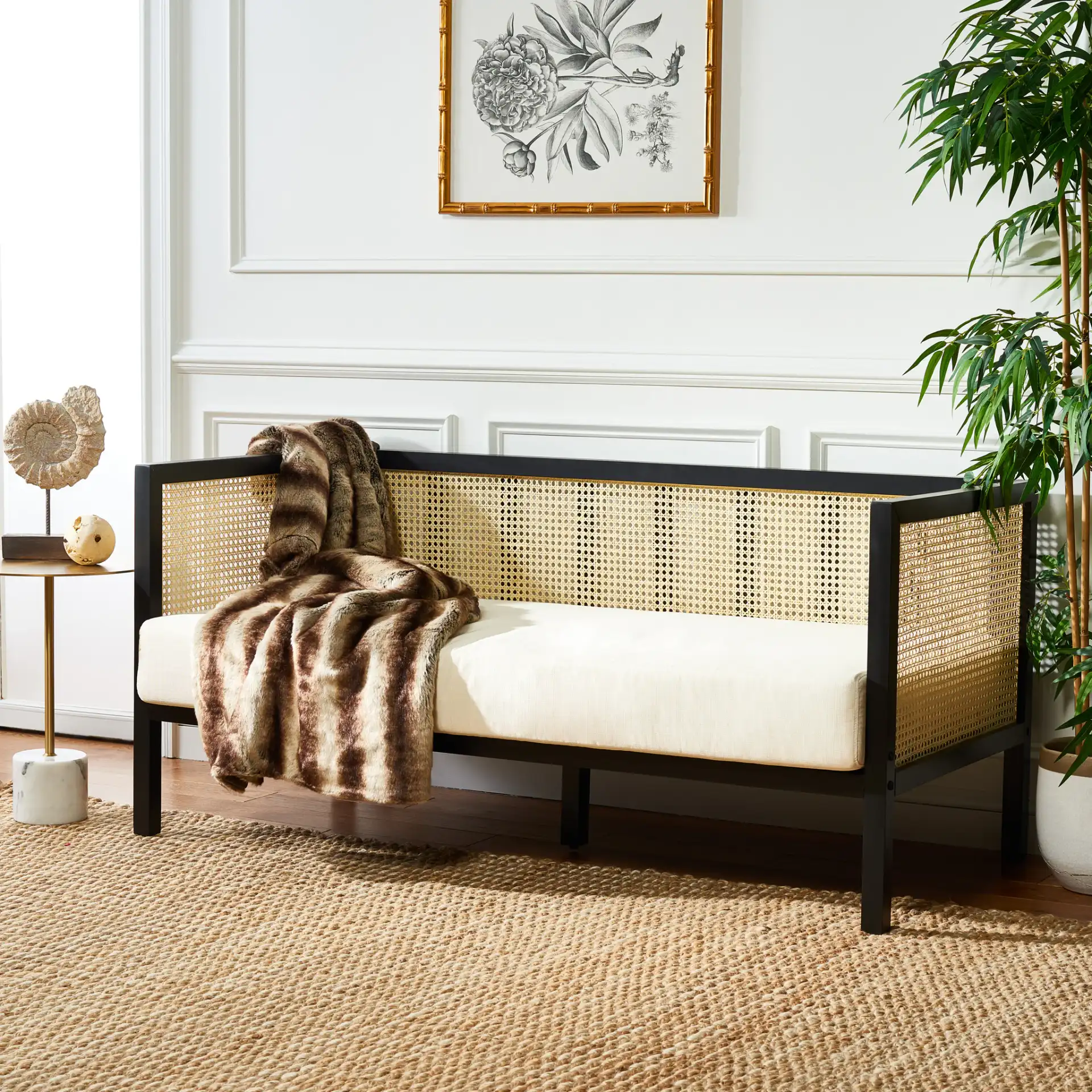 Maude Rattan Three-Seater Sofa in Black in a styled room