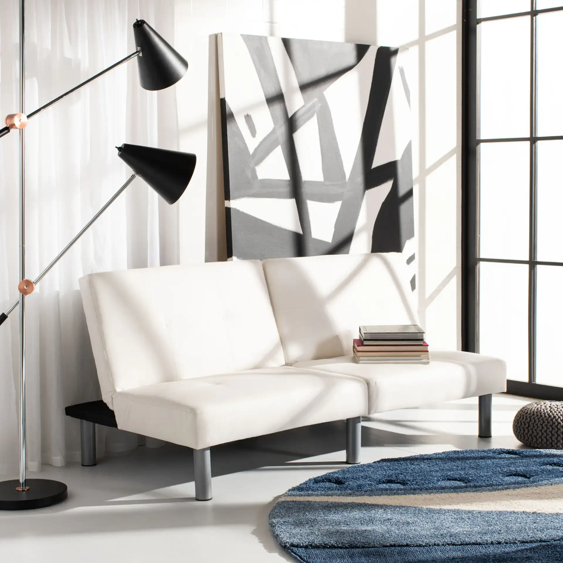 Noho Foldable Futon Bed in White / Silver in a styled room
