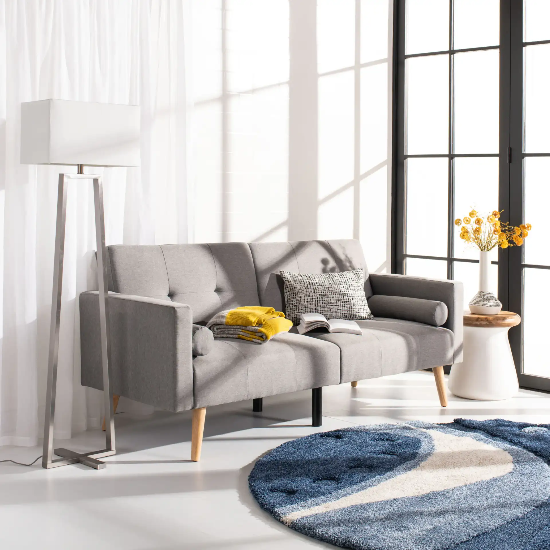 Astoria Foldable Futon Bed in Navy / Black in a styled room