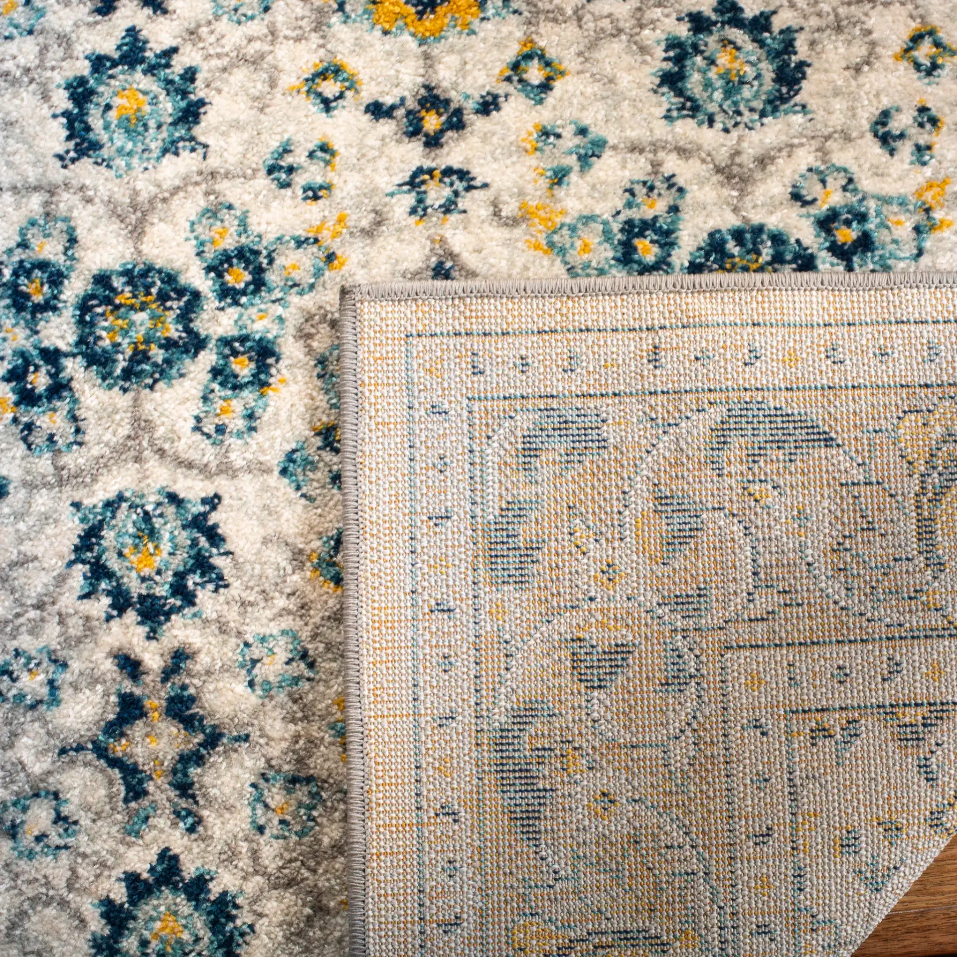 Madison Floral Bordered Rug in Ivory / Navy in a styled room