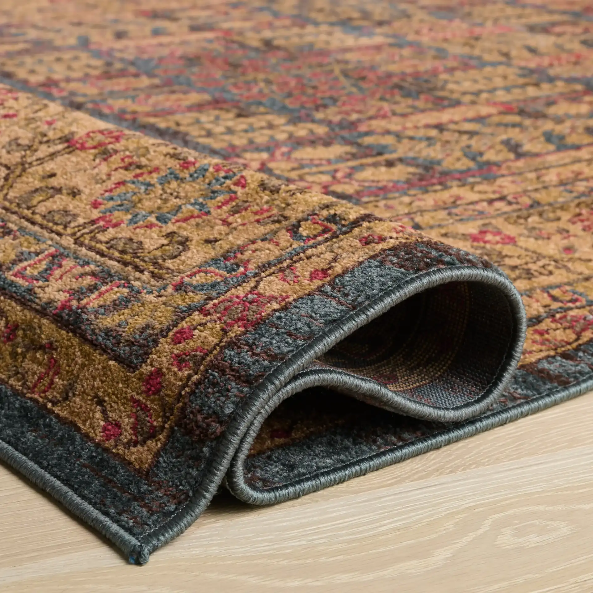 Mahal Botanical Bordered Rug in Navy / Natural in a styled room