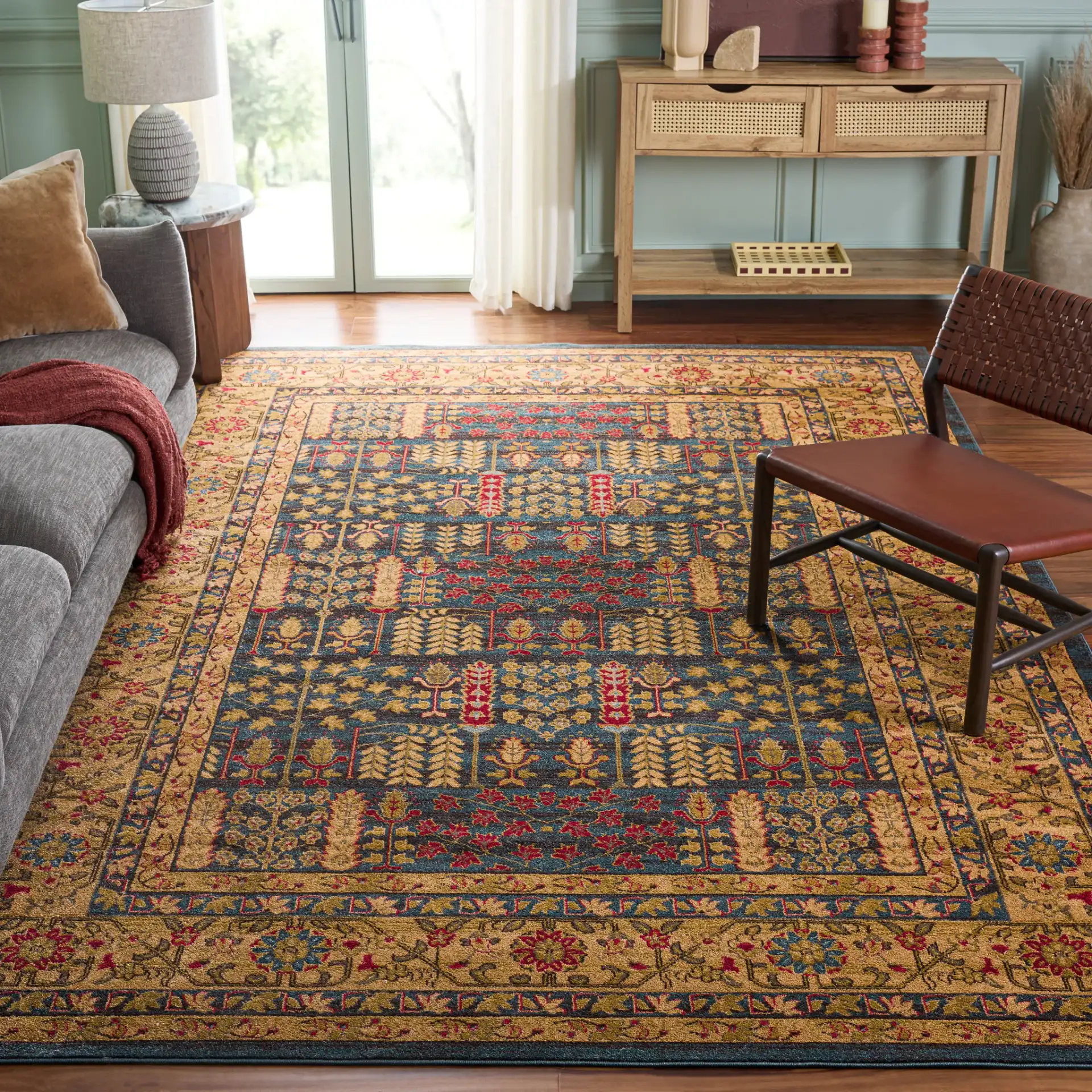 Mahal Botanical Bordered Rug in Navy / Natural in a styled room