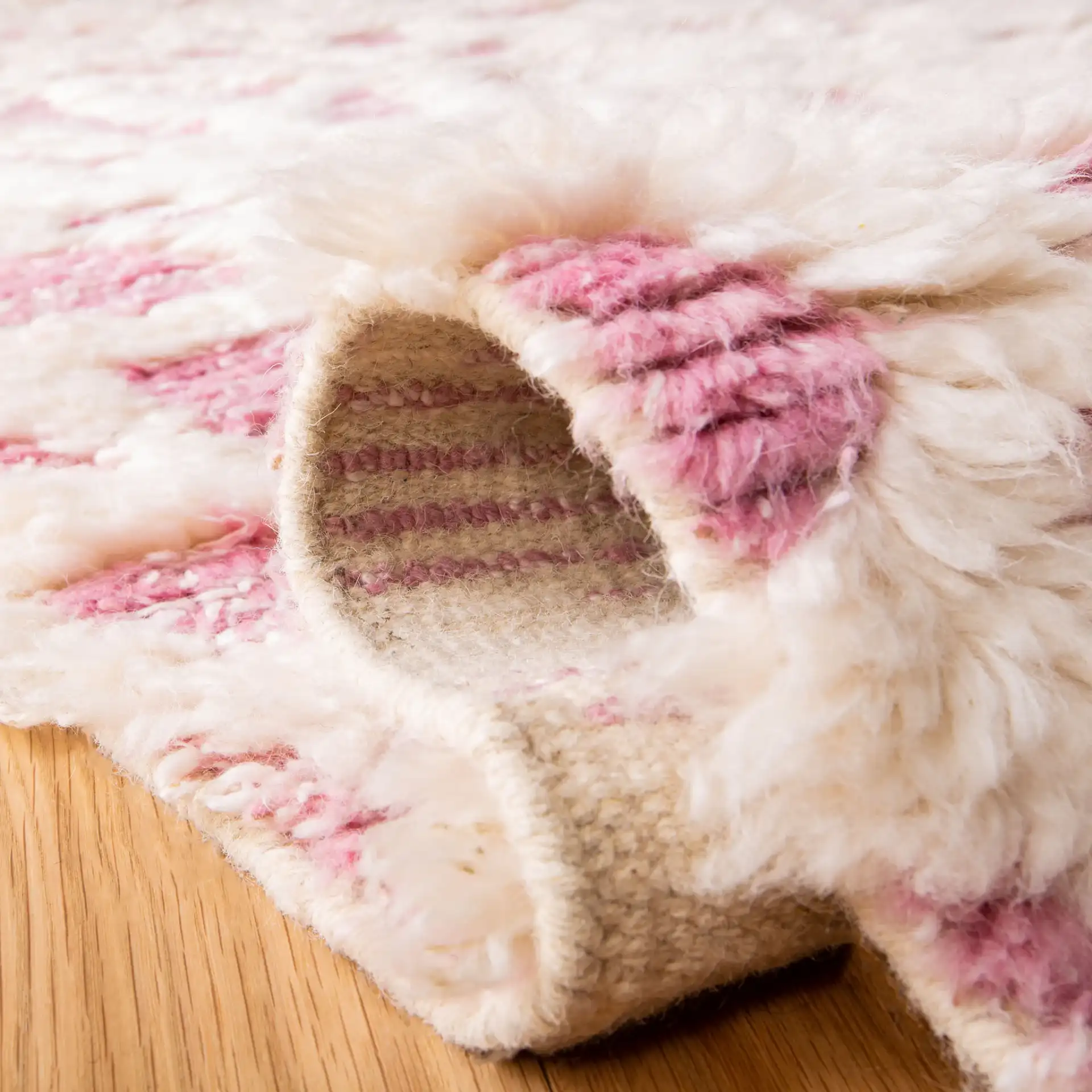 Manhattan Tribal Lattice Hand-Knotted Wool Rug in Ivory / Pink in a styled room