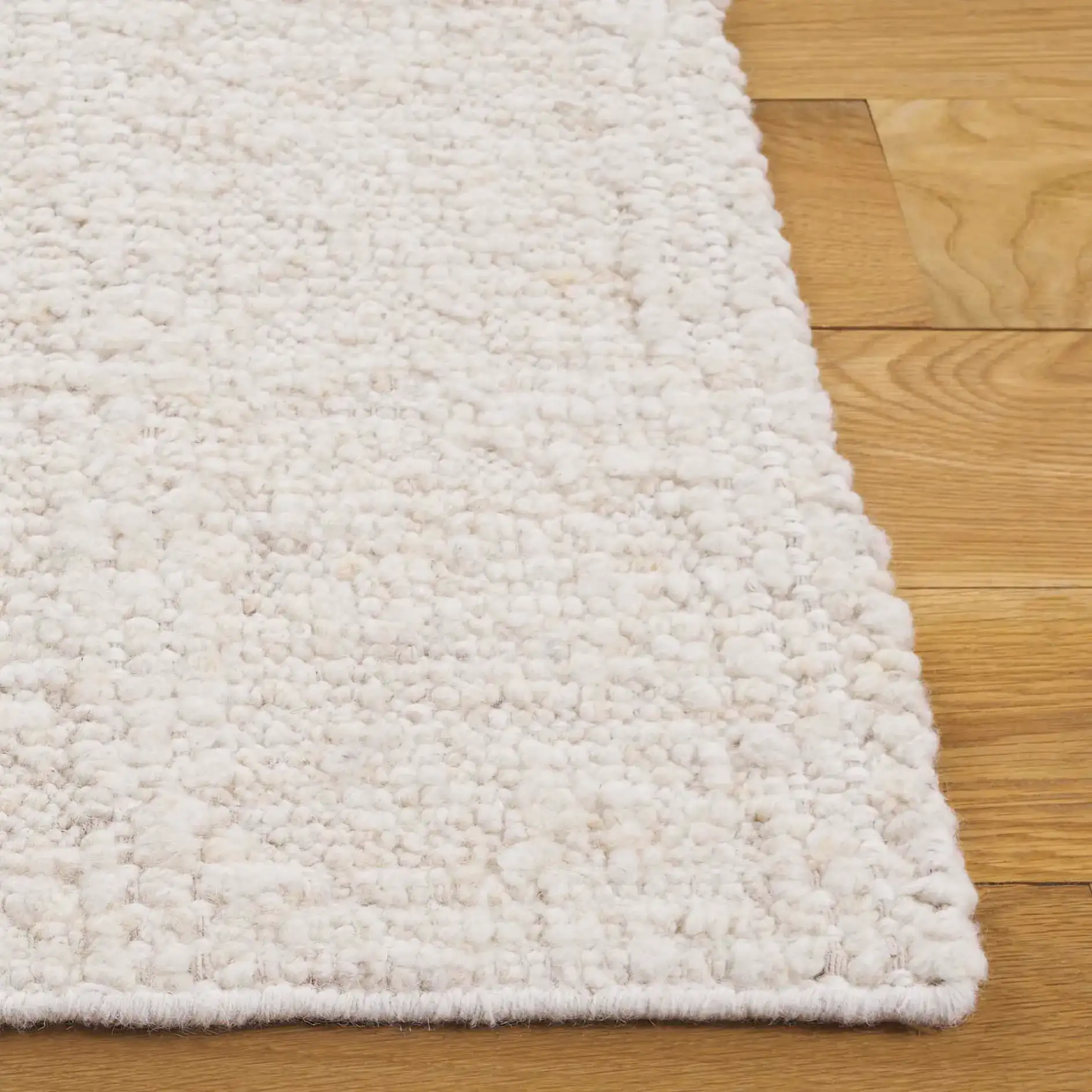 Manhattan Ribbed Solid Hand-Woven Wool Rug in Ivory in a styled room