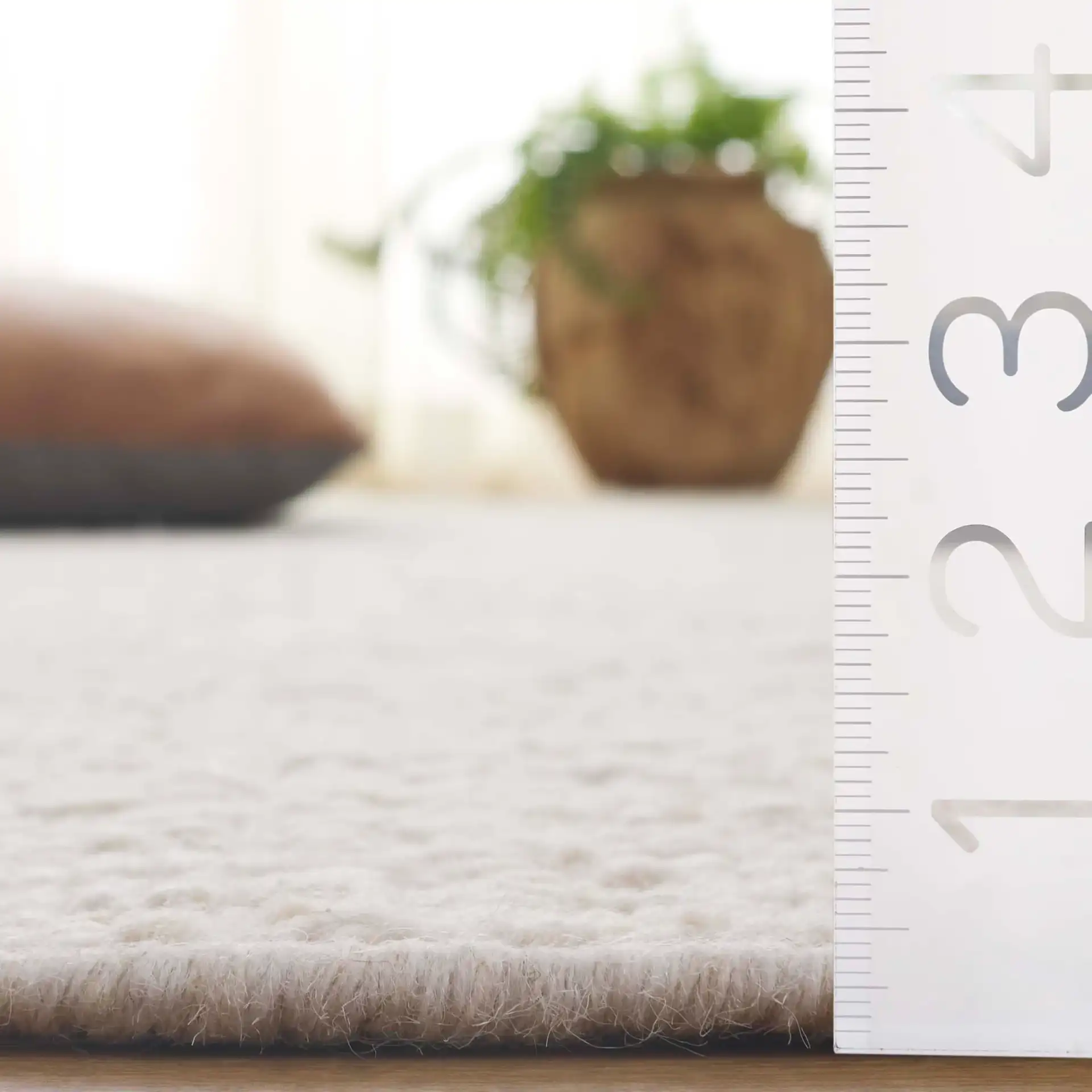 Manhattan Ribbed Solid Hand-Woven Wool Rug in Ivory in a styled room