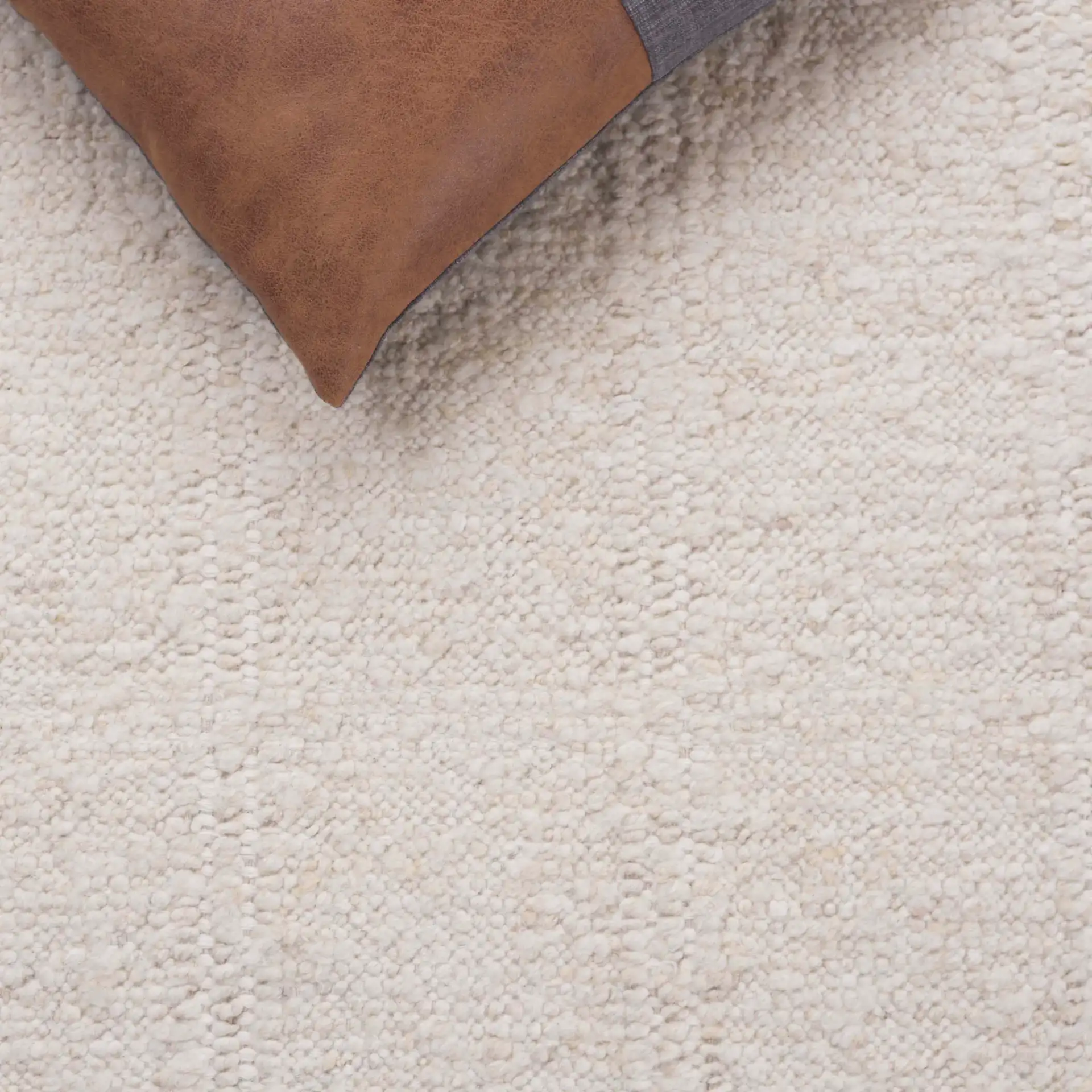 Manhattan Ribbed Solid Hand-Woven Wool Rug in Ivory in a styled room