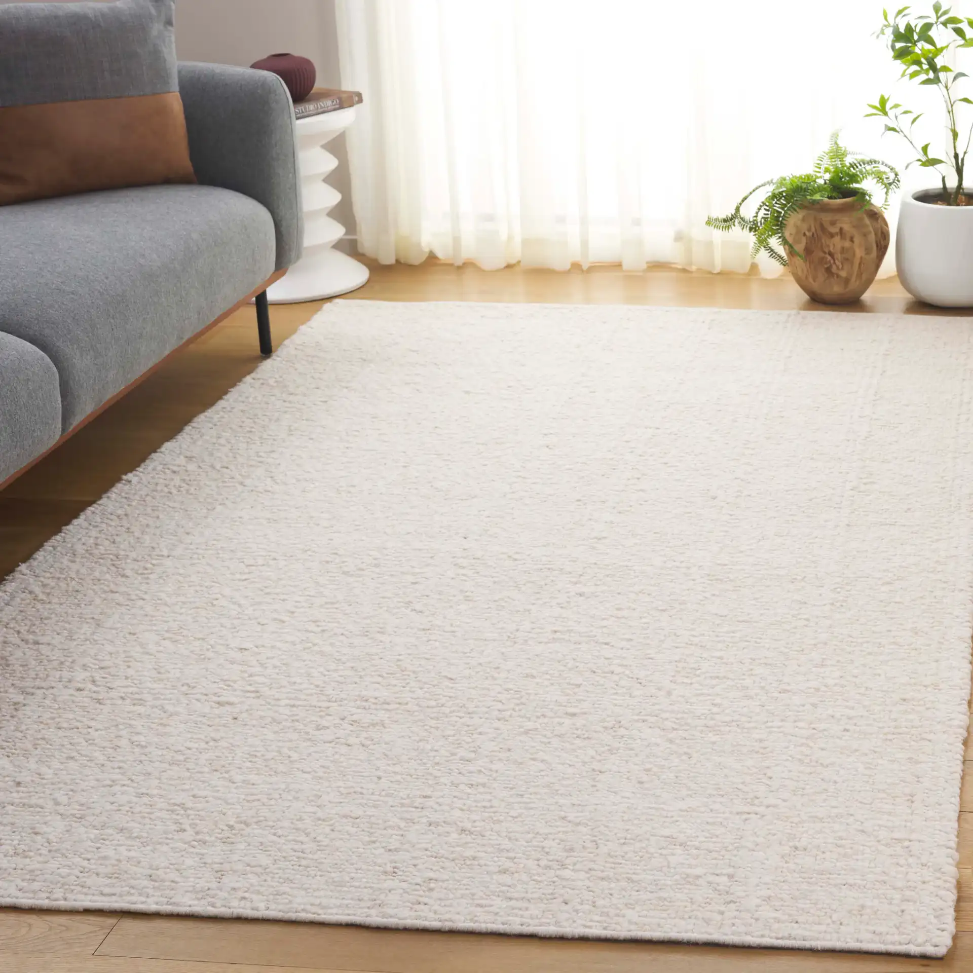 Manhattan Ribbed Solid Hand-Woven Wool Rug in Ivory in a styled room