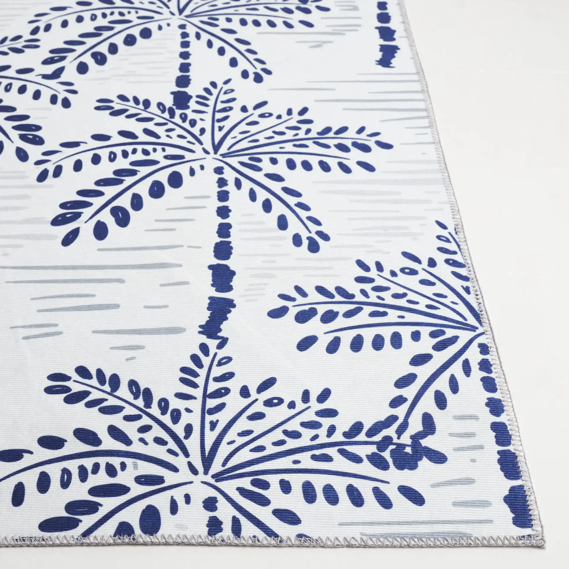 Malibu Palm Tree Washable Rug in Ivory / Navy in a styled room