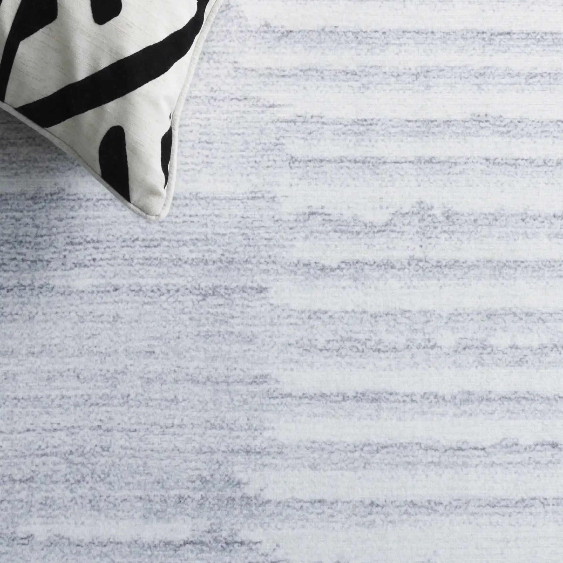 Malibu Gradient Stripe Washable Rug in Light Gray / Gray in a styled room