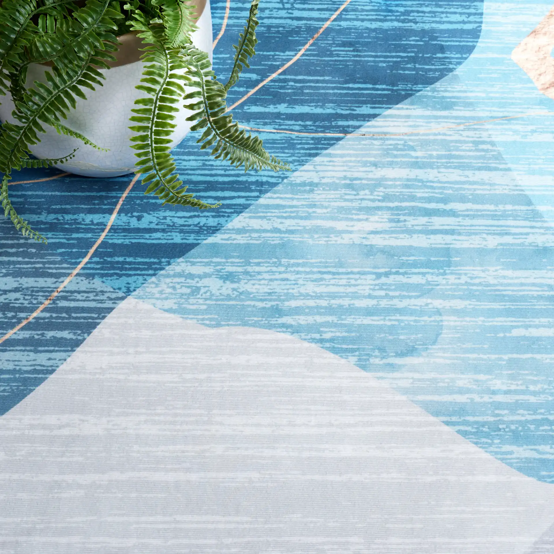 Malibu Modern Abstract Washable Rug in Blue / Gold in a styled room