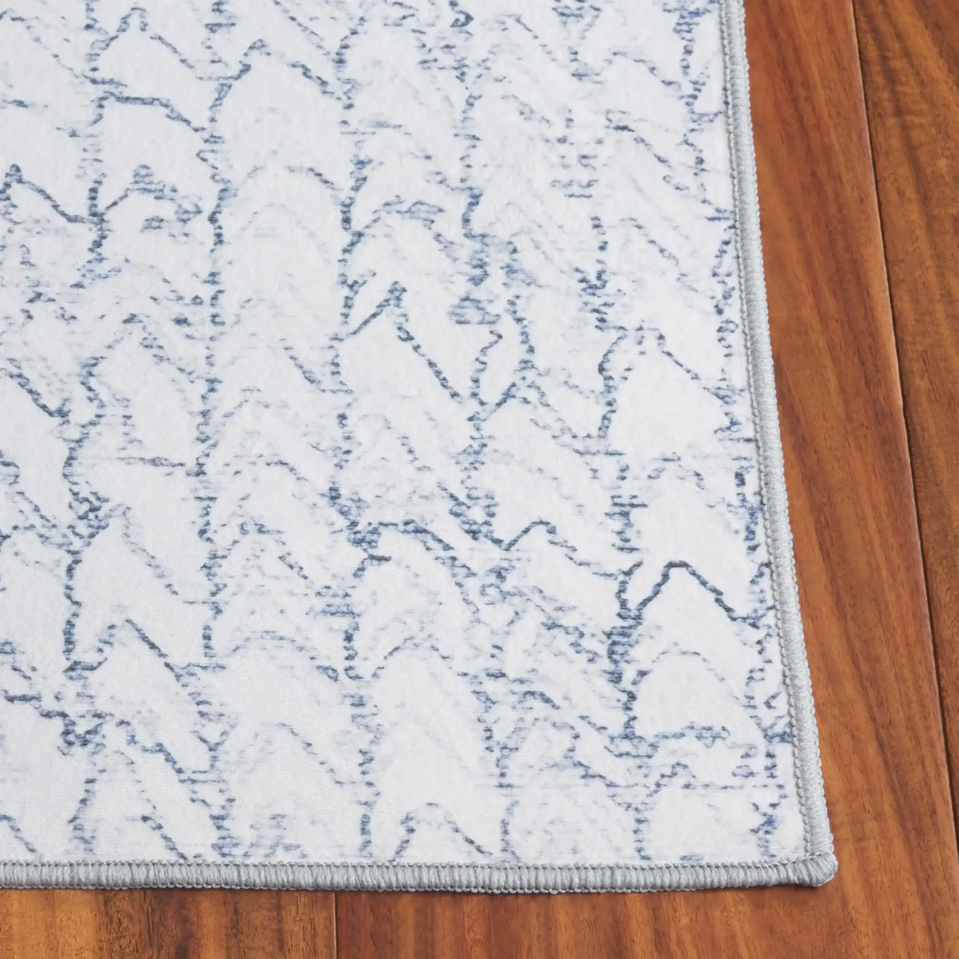 Malibu Sketched Chevron Washable Rug in Gray / Blue in a styled room
