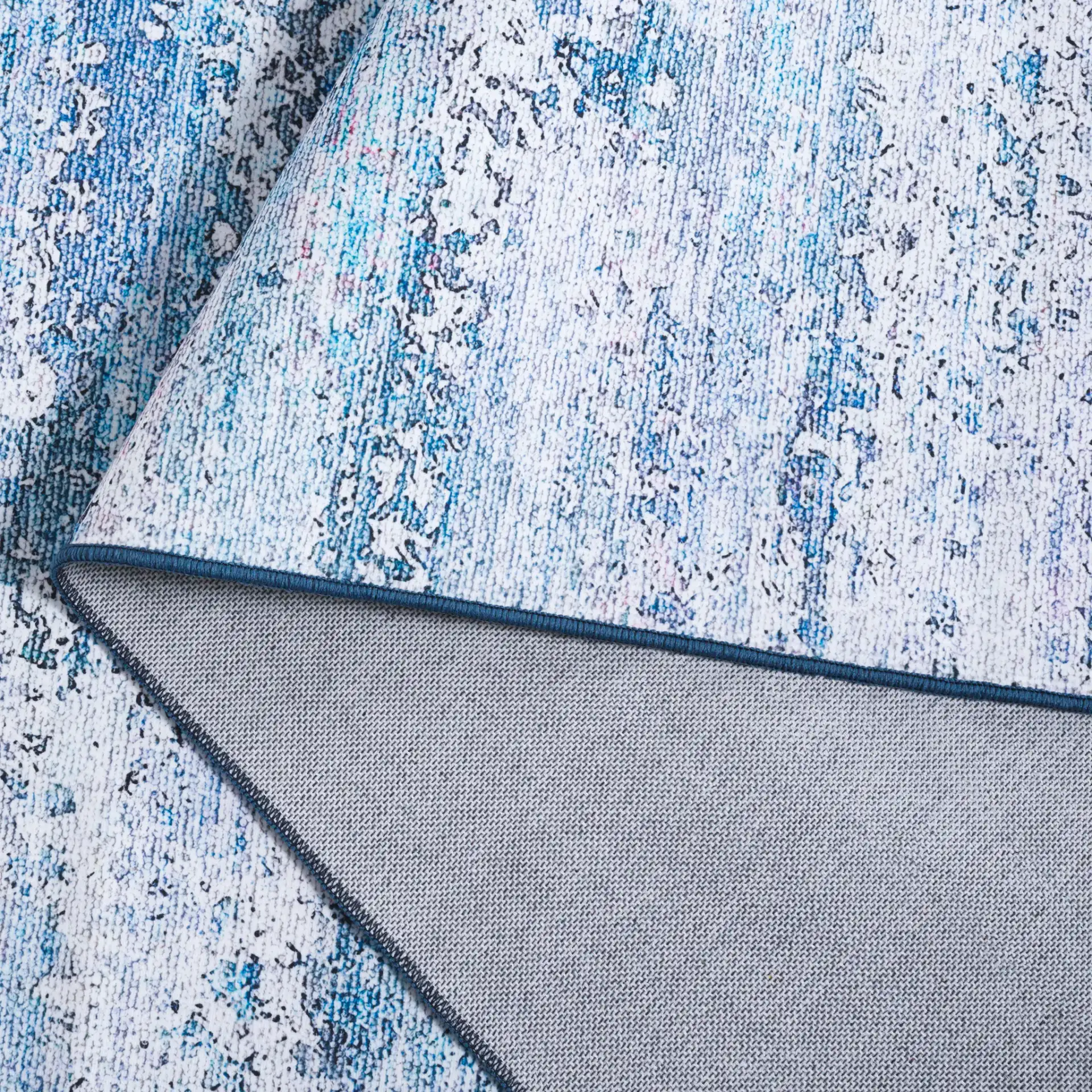 Malibu Faded Abstract Washable Rug in Gray / Blue in a styled room