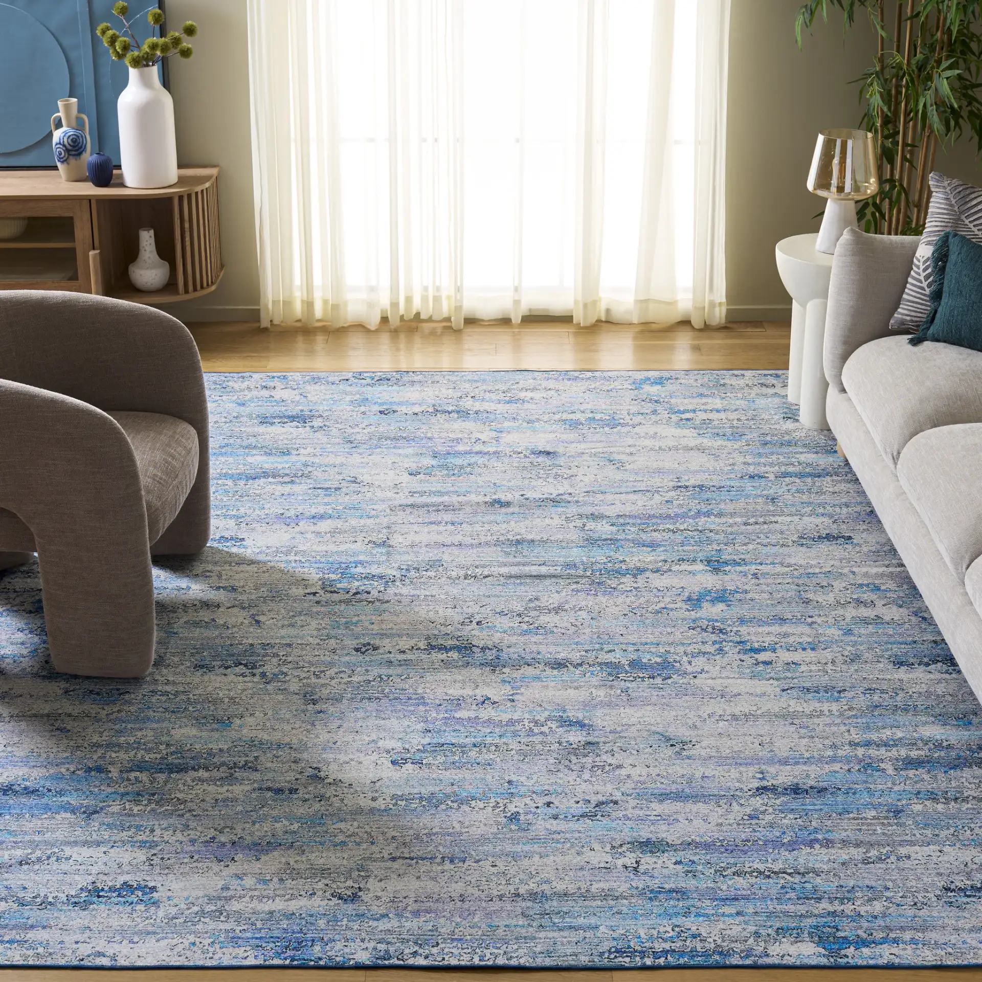 Malibu Faded Abstract Washable Rug in Gray / Blue in a styled room