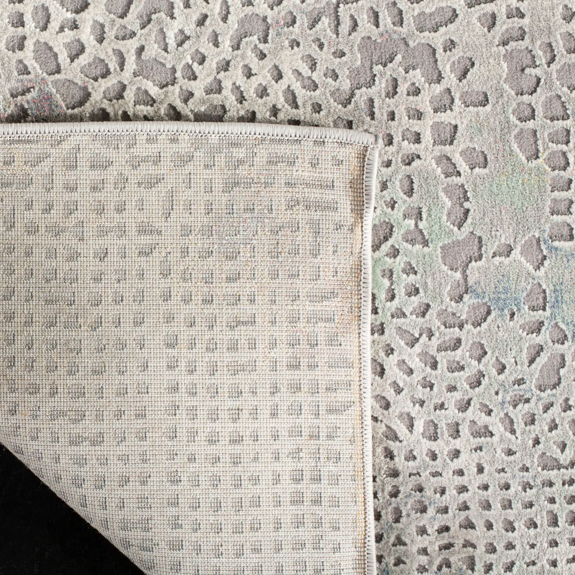 Meadow Textured Dot Abstract Rug in Gray / Gold in a styled room