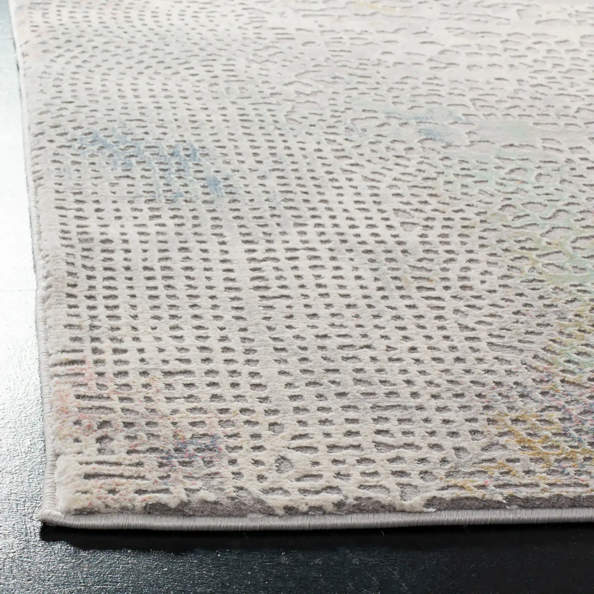 Meadow Textured Dot Abstract Rug in Gray / Gold in a styled room