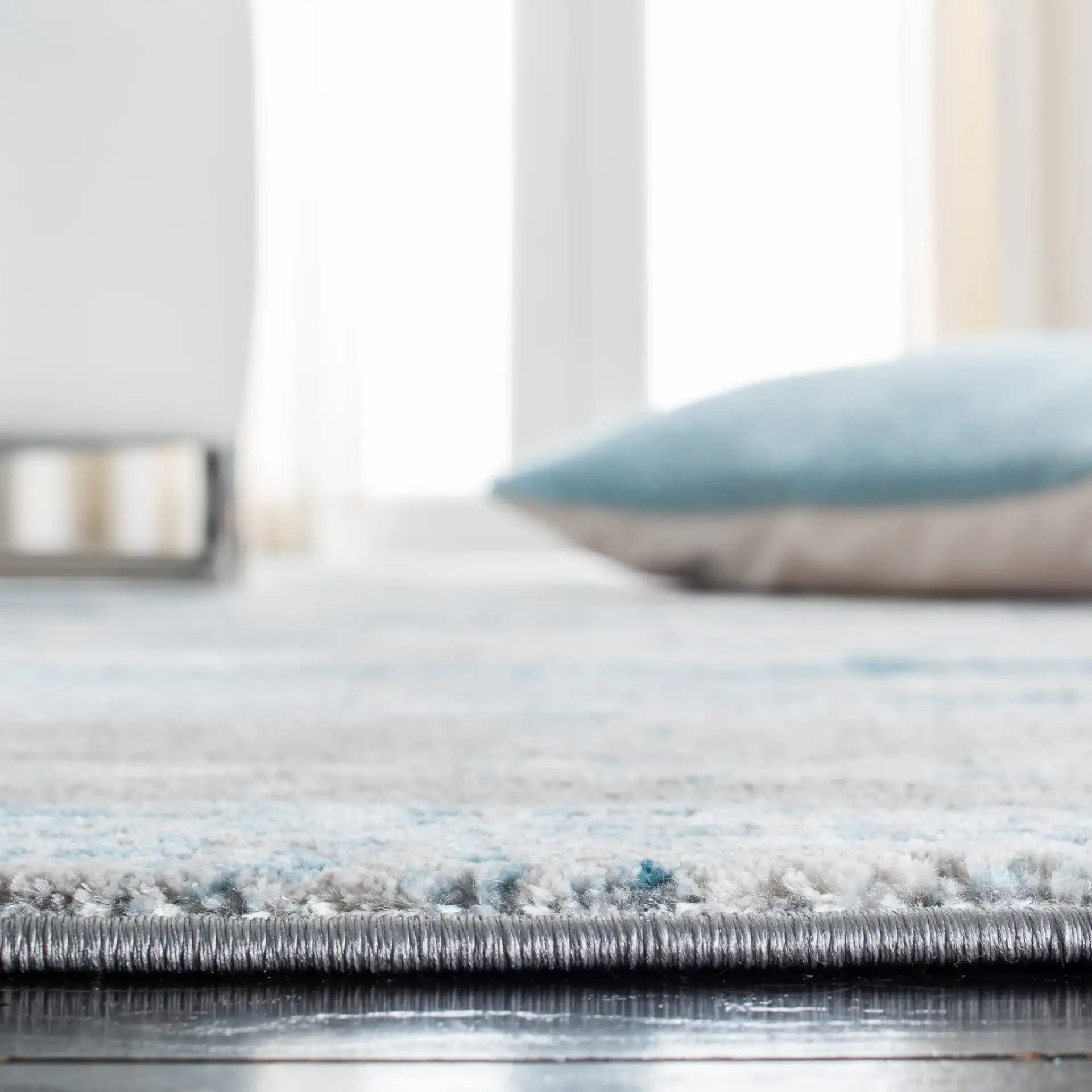 Meadow Abstract Landscape Rug in Light Gray / Blue in a styled room