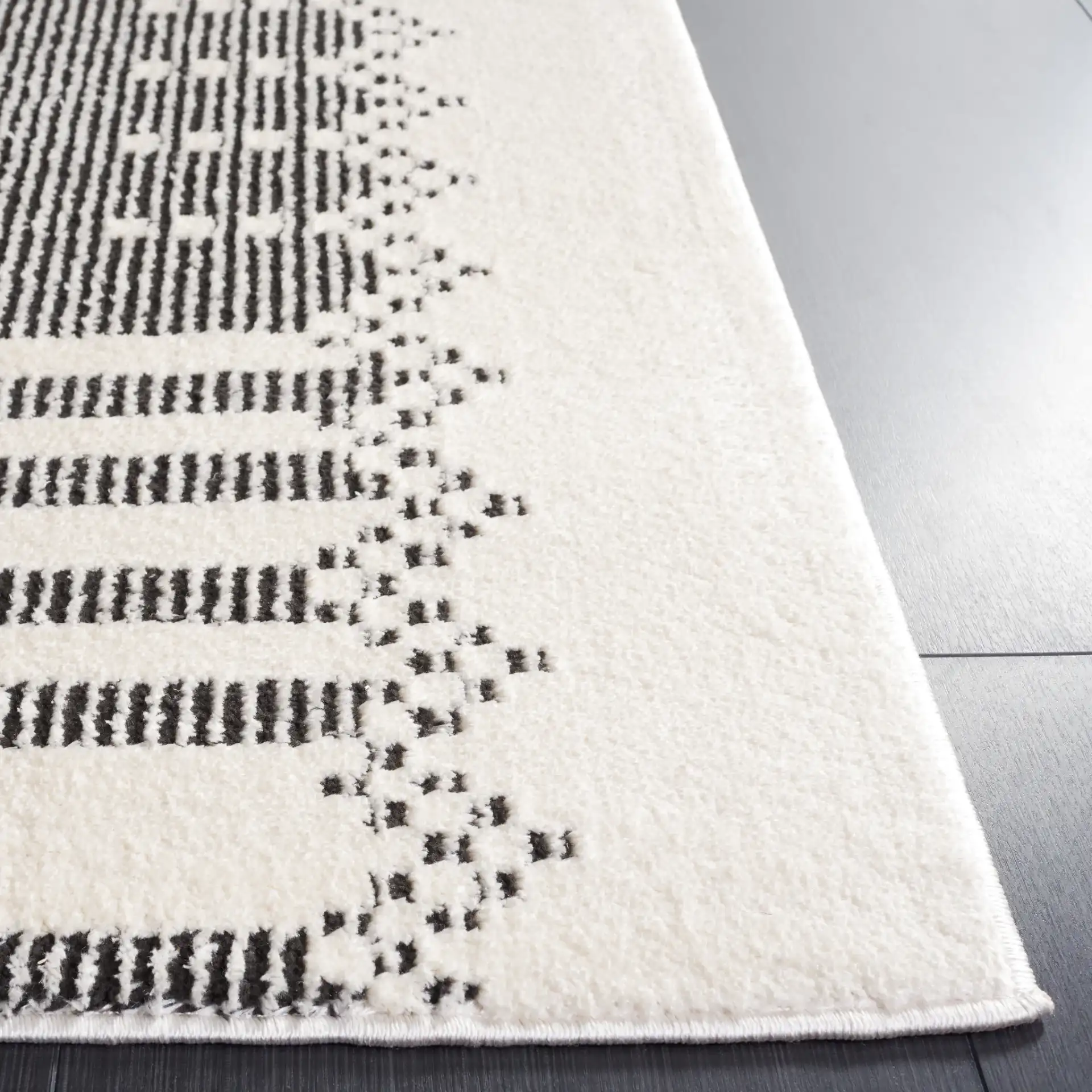 Melody Striped Border Rug in Ivory / Black in a styled room