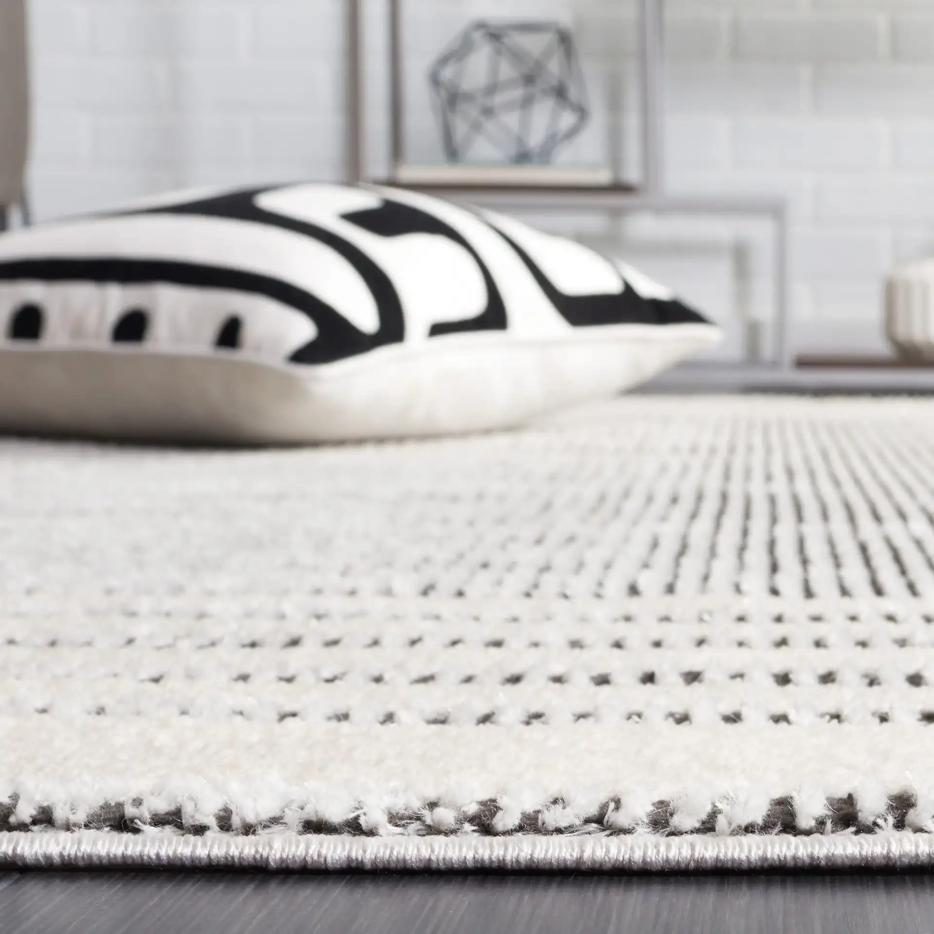 Melody Striped Border Rug in Ivory / Black in a styled room