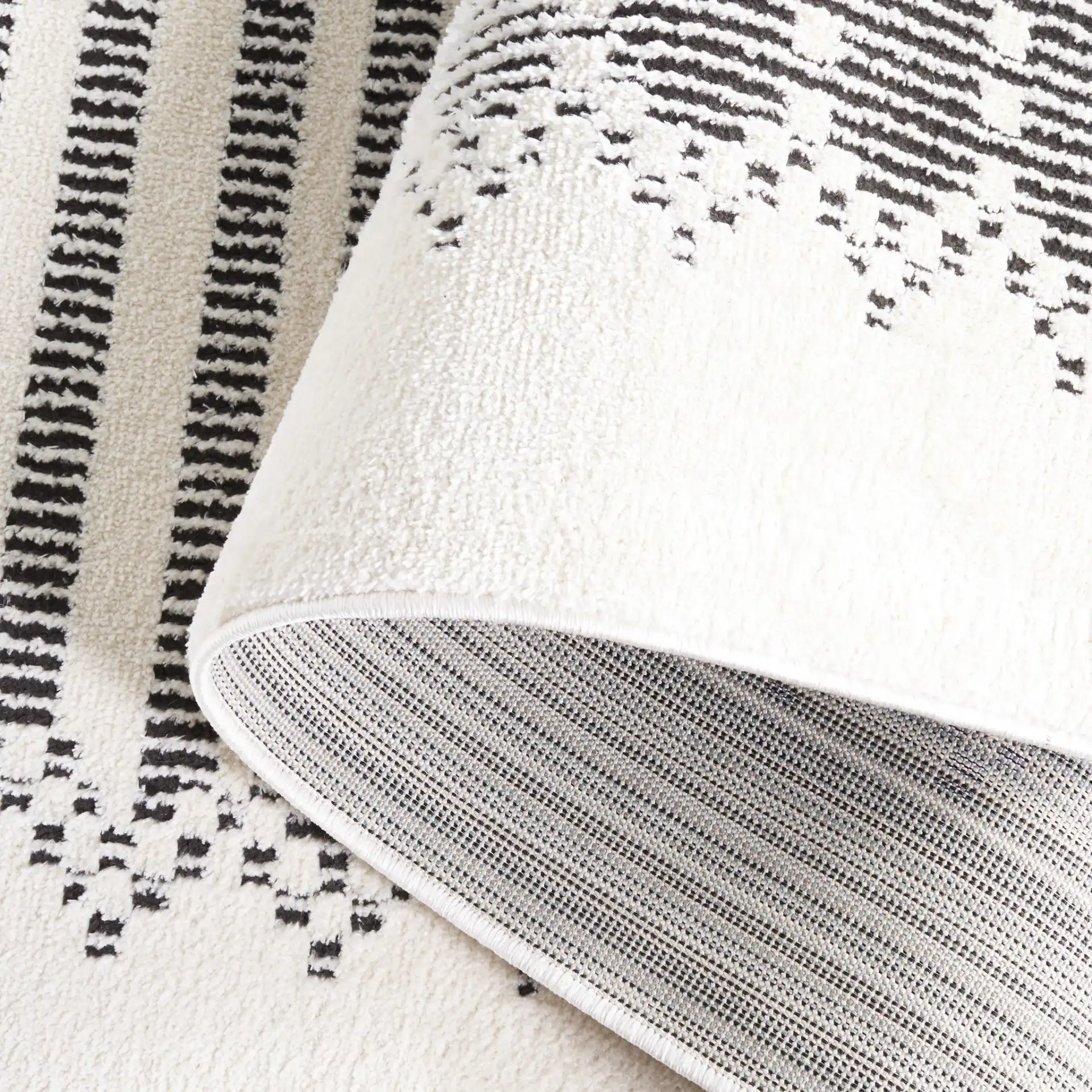 Melody Striped Border Rug in Ivory / Black in a styled room