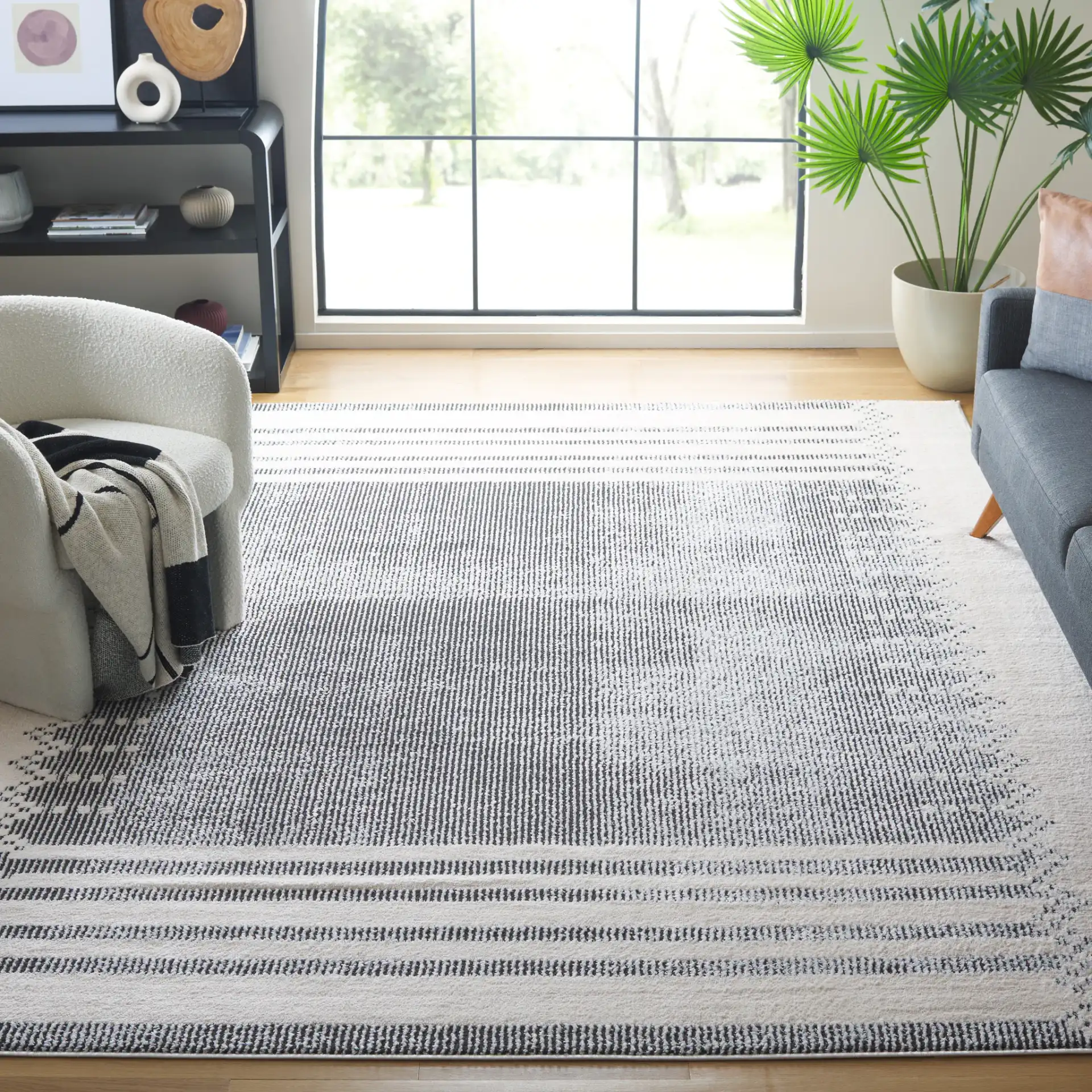 Melody Striped Border Rug in Ivory / Black in a styled room