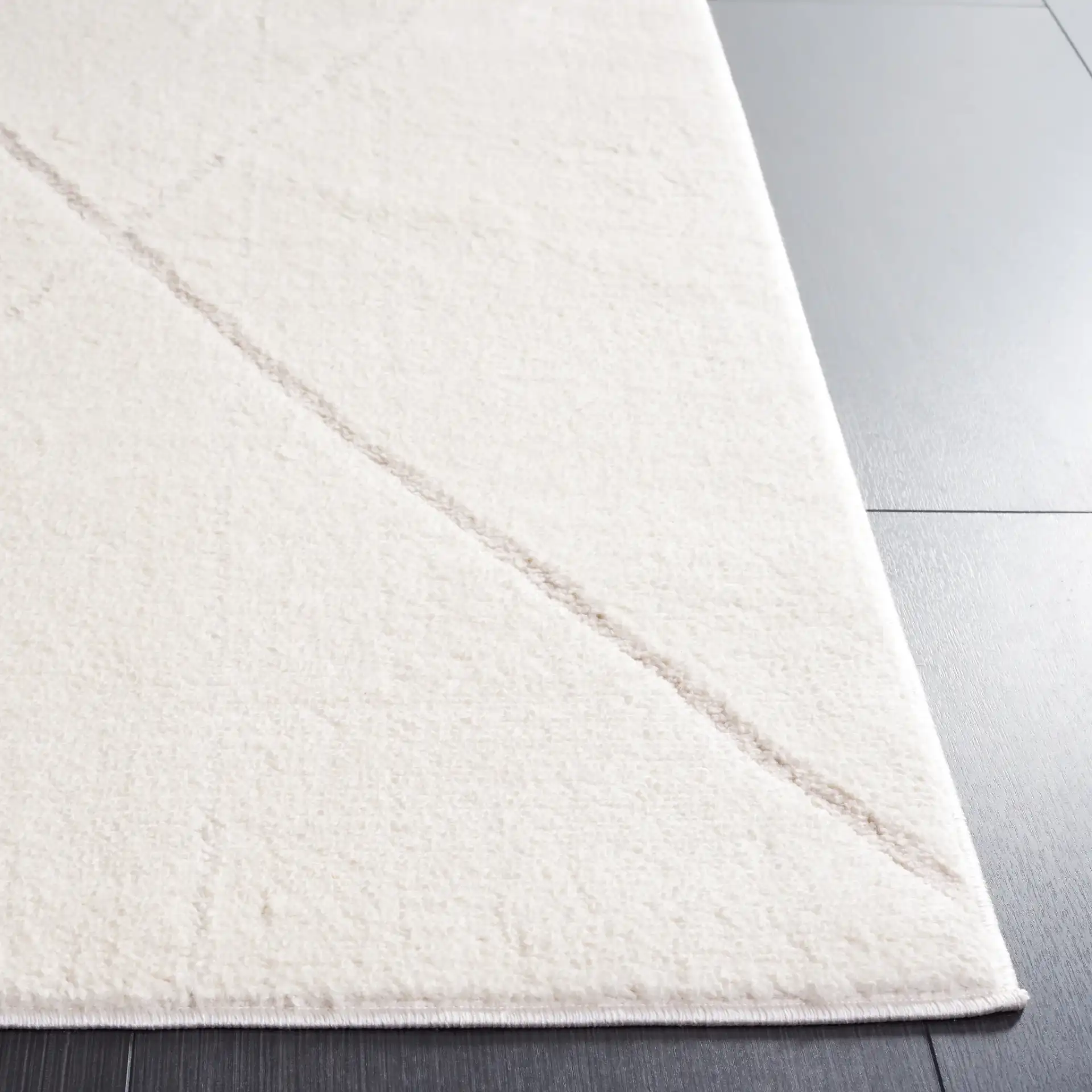Melody Carved Diamond Rug in Ivory / Beige in a styled room