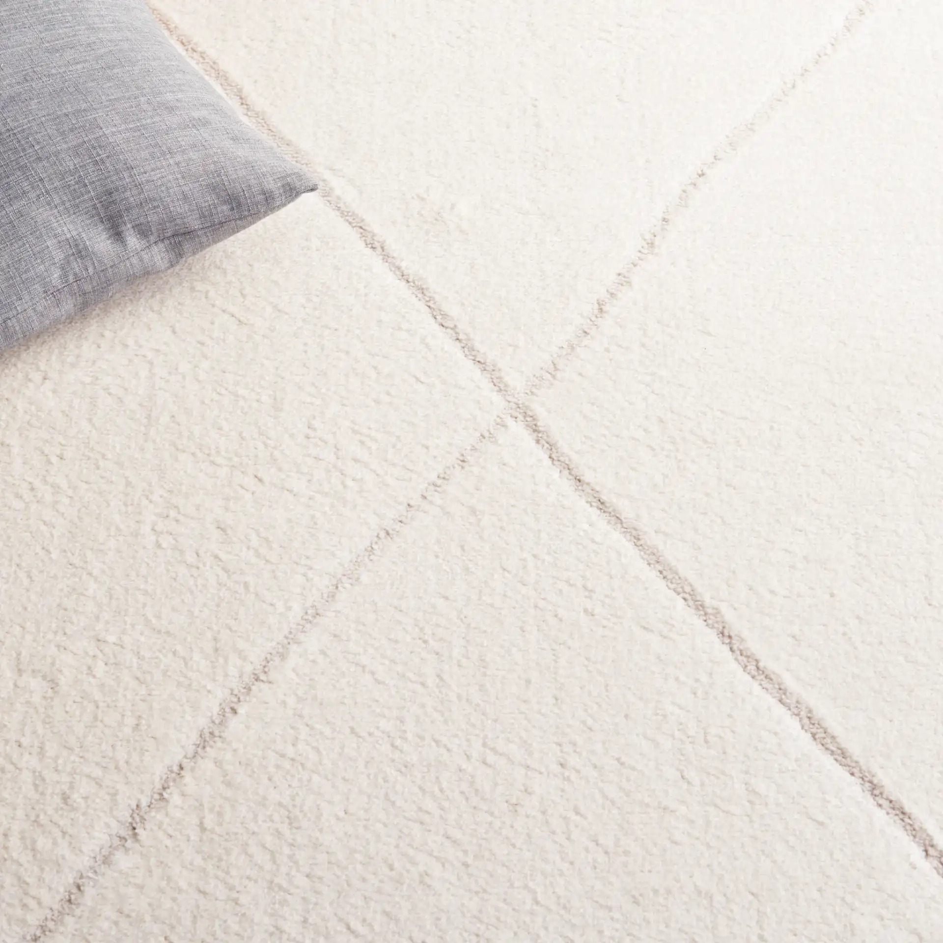 Melody Carved Diamond Rug in Ivory / Beige in a styled room
