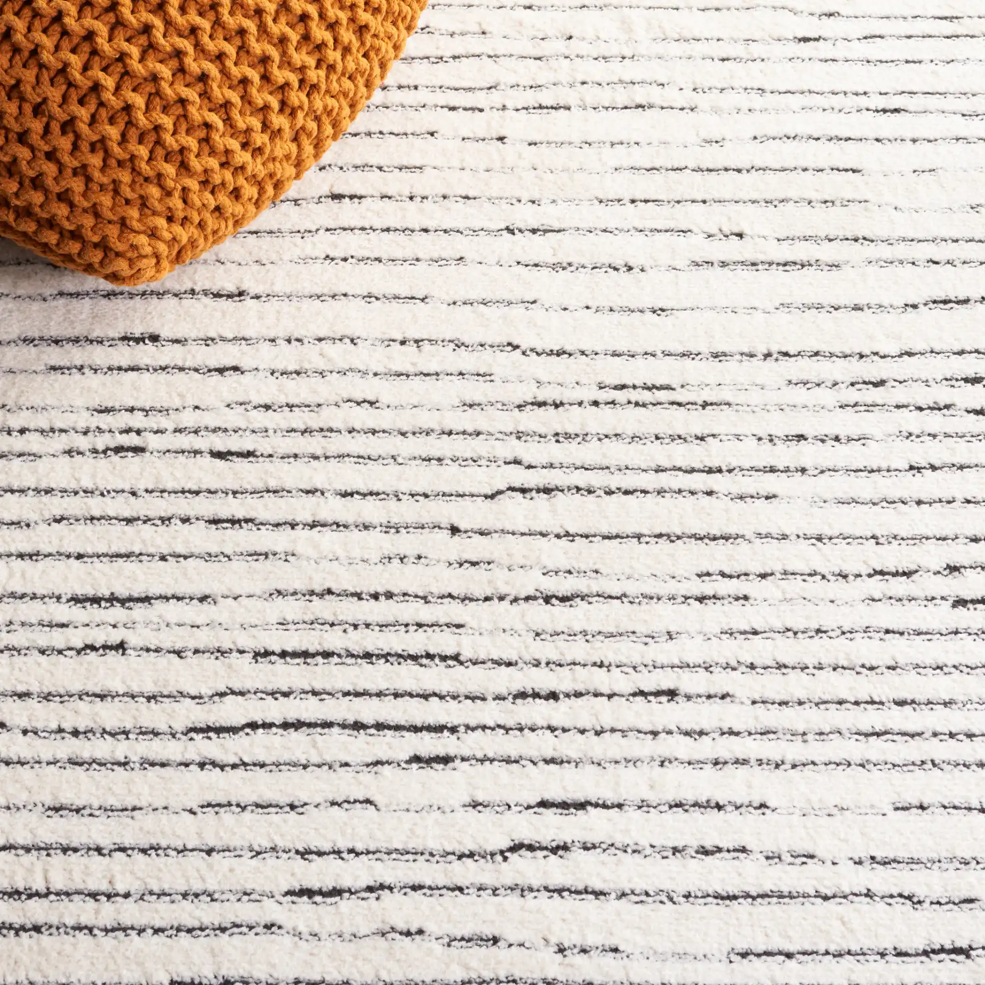 Melody Broken Stripe Rug in Ivory / Black in a styled room