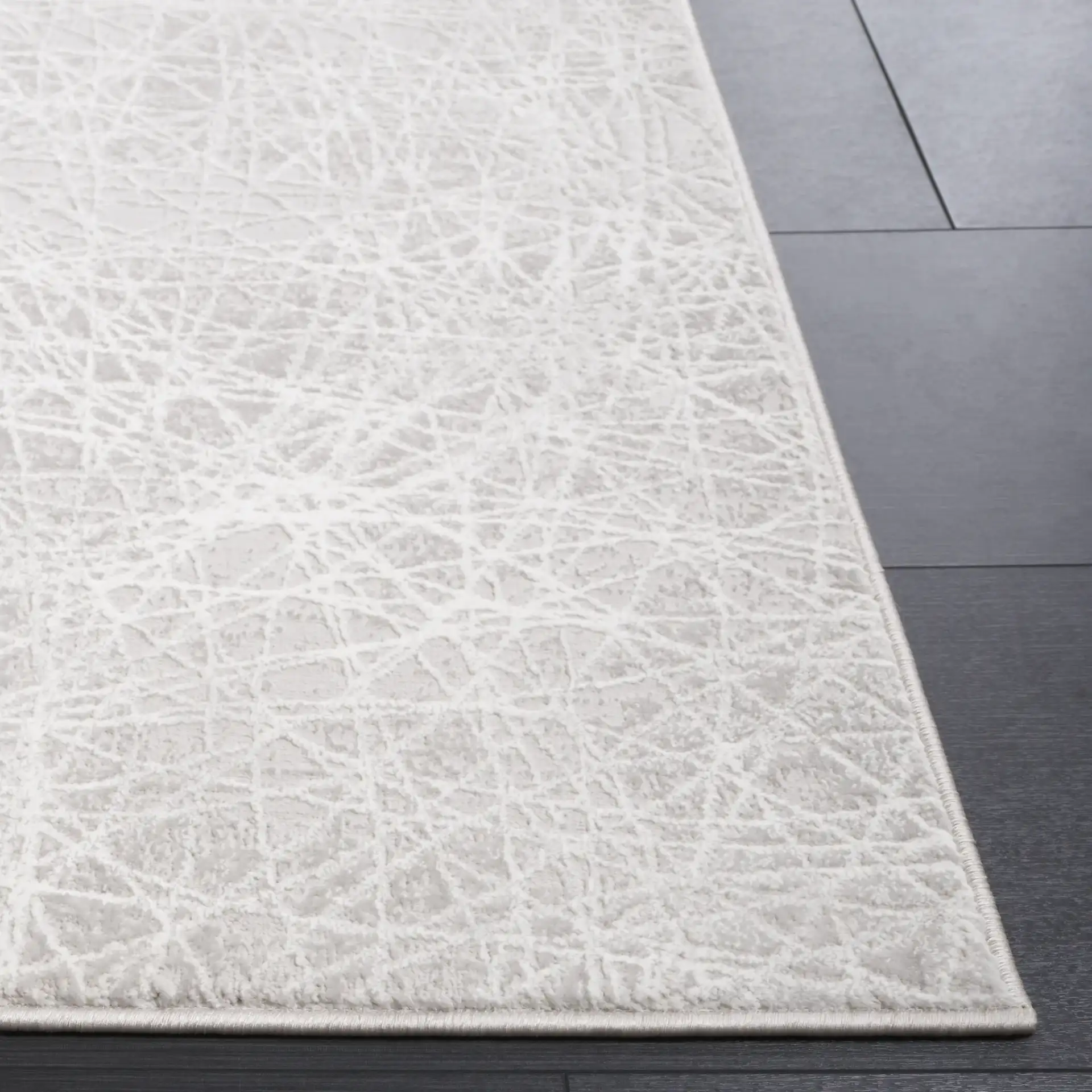 Memphis Abstract Web Rug in Gray / Ivory in a styled room