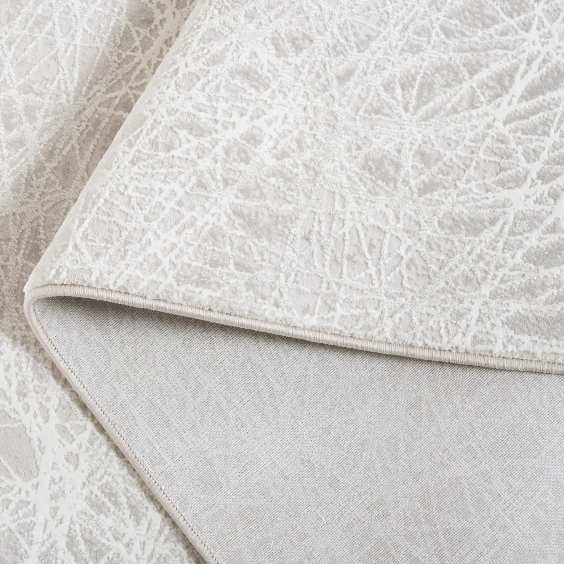Memphis Abstract Web Rug in Gray / Ivory in a styled room
